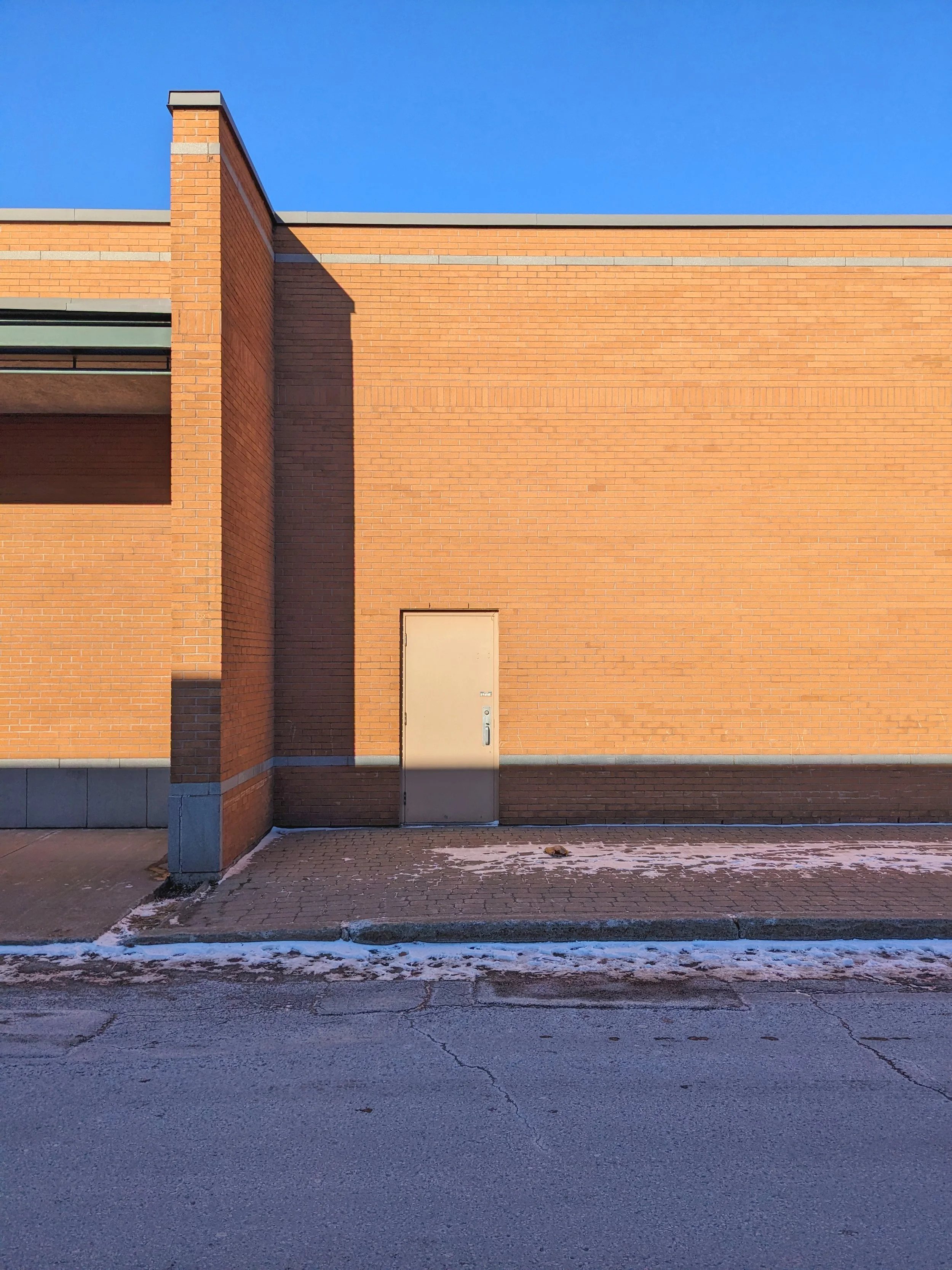 Minimal architecture of shapes and colors, suburban vernacular and strange beauty in everyday liminal places. 