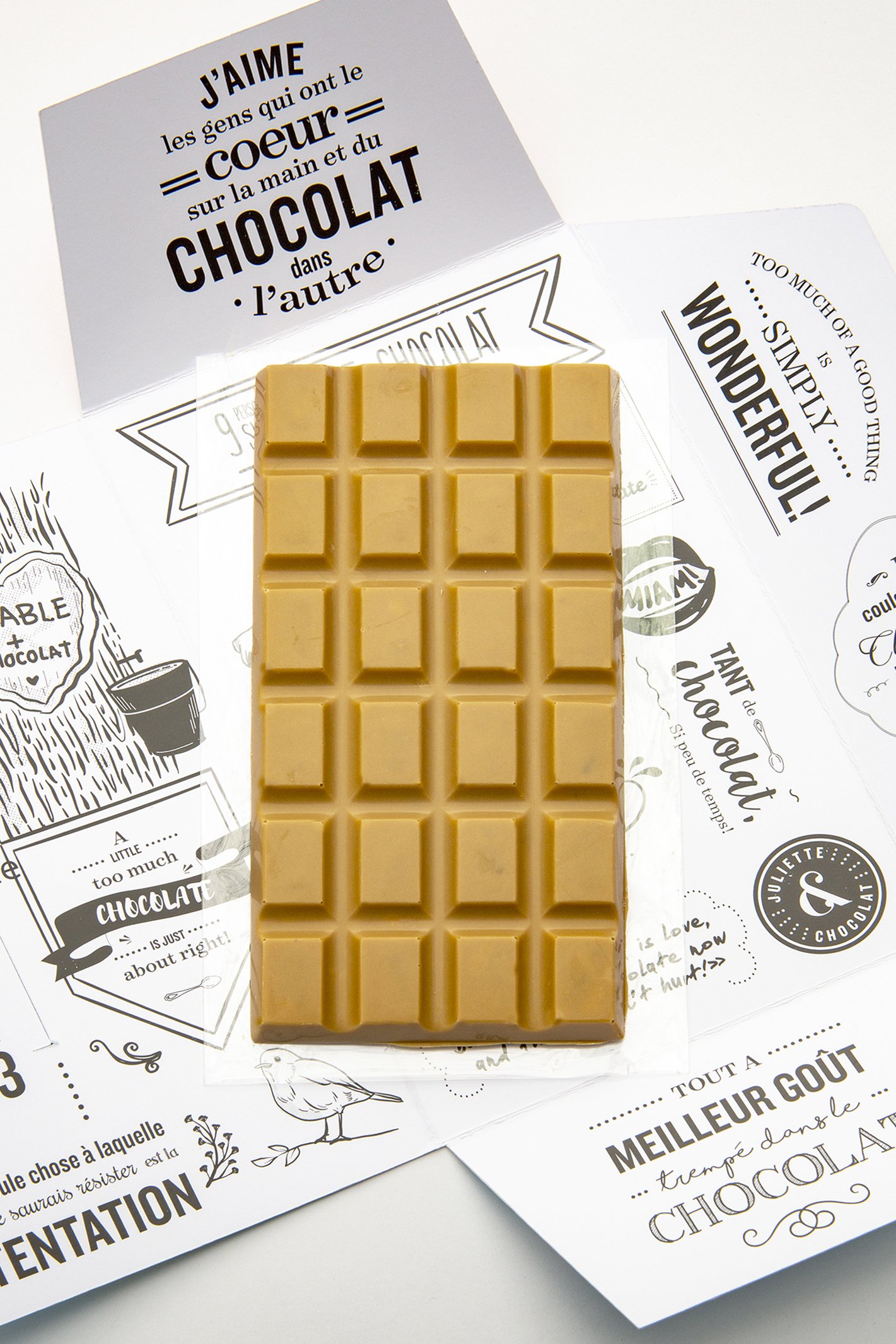 Blond chocolate and maple chocolate bar on white packaging with fun quotes. 