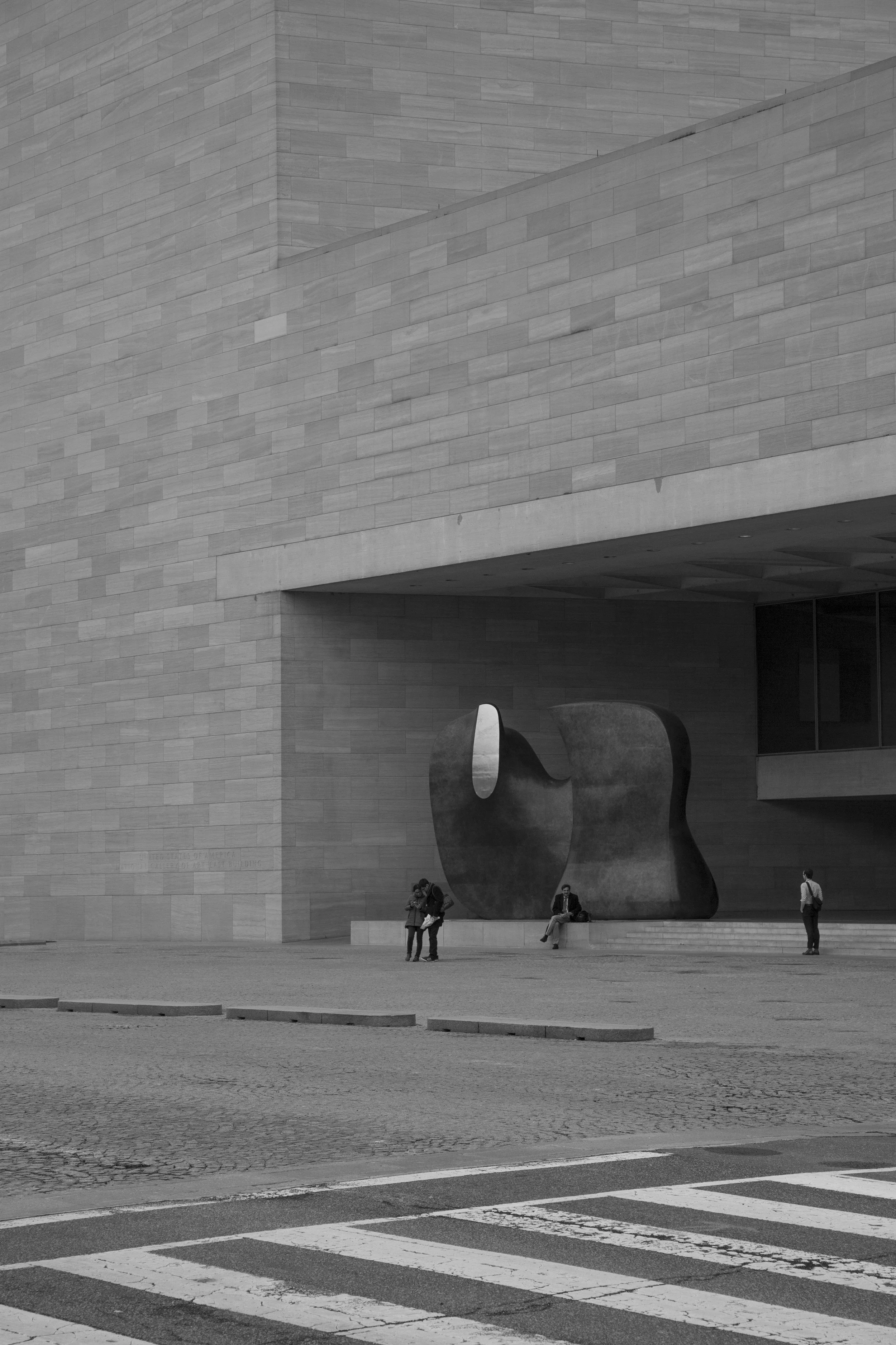Entrance to the National Gallery art museum in Washington DC, black and white architectural photo with art and perspective lines. 