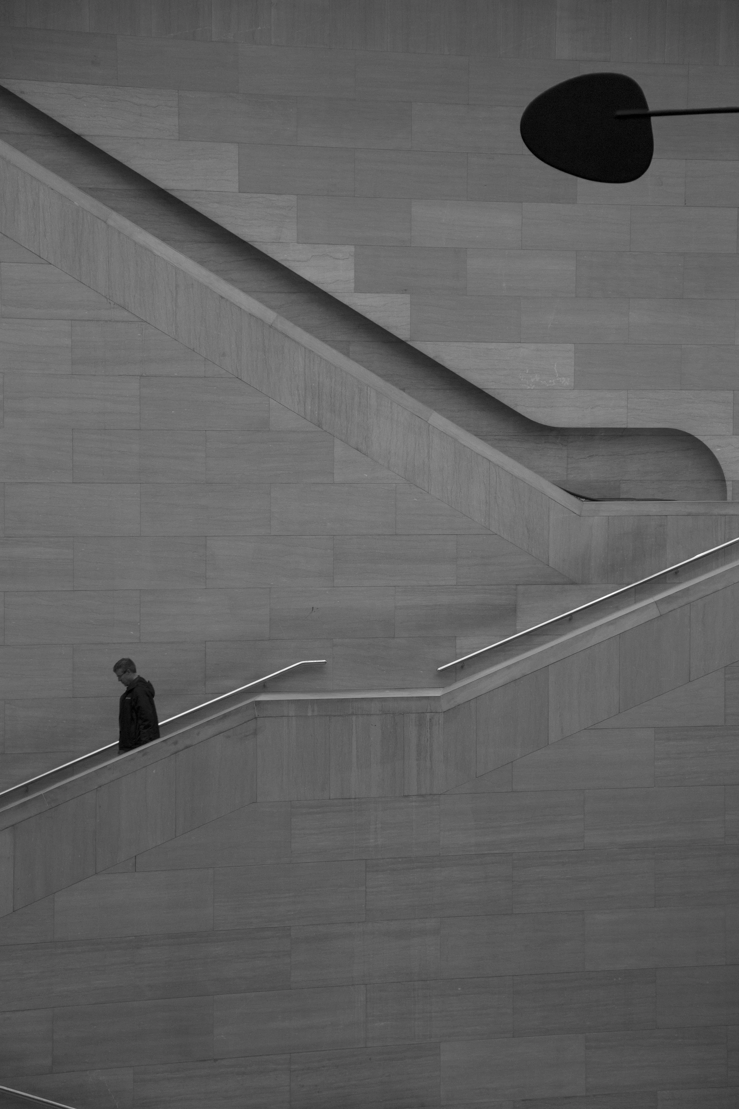 Museum stone staircase, architectural photography, beautiful composition with silhouettes against pale stone