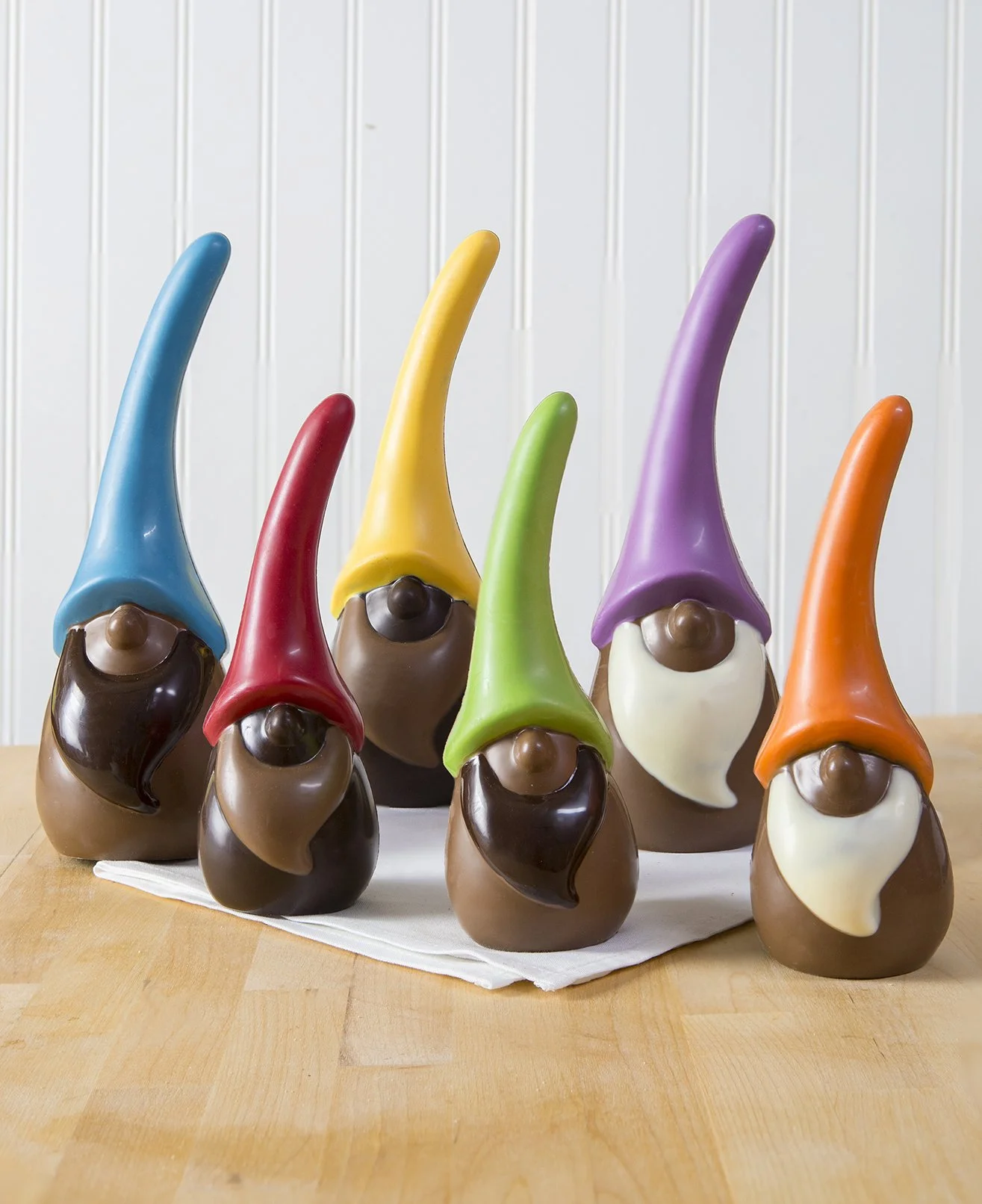 Chocolate Easter gnomes with colorful white chocolate hats and dark and milk chocolate bodies