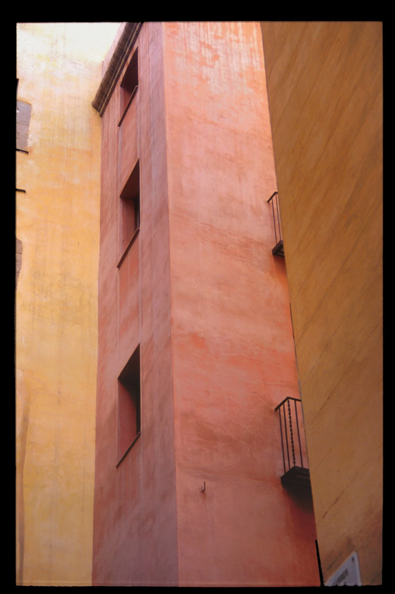 Red and yellow buildings in Barcelona, Spain, minimalist colorful architecture, color travel photography from Europe by Lionel May