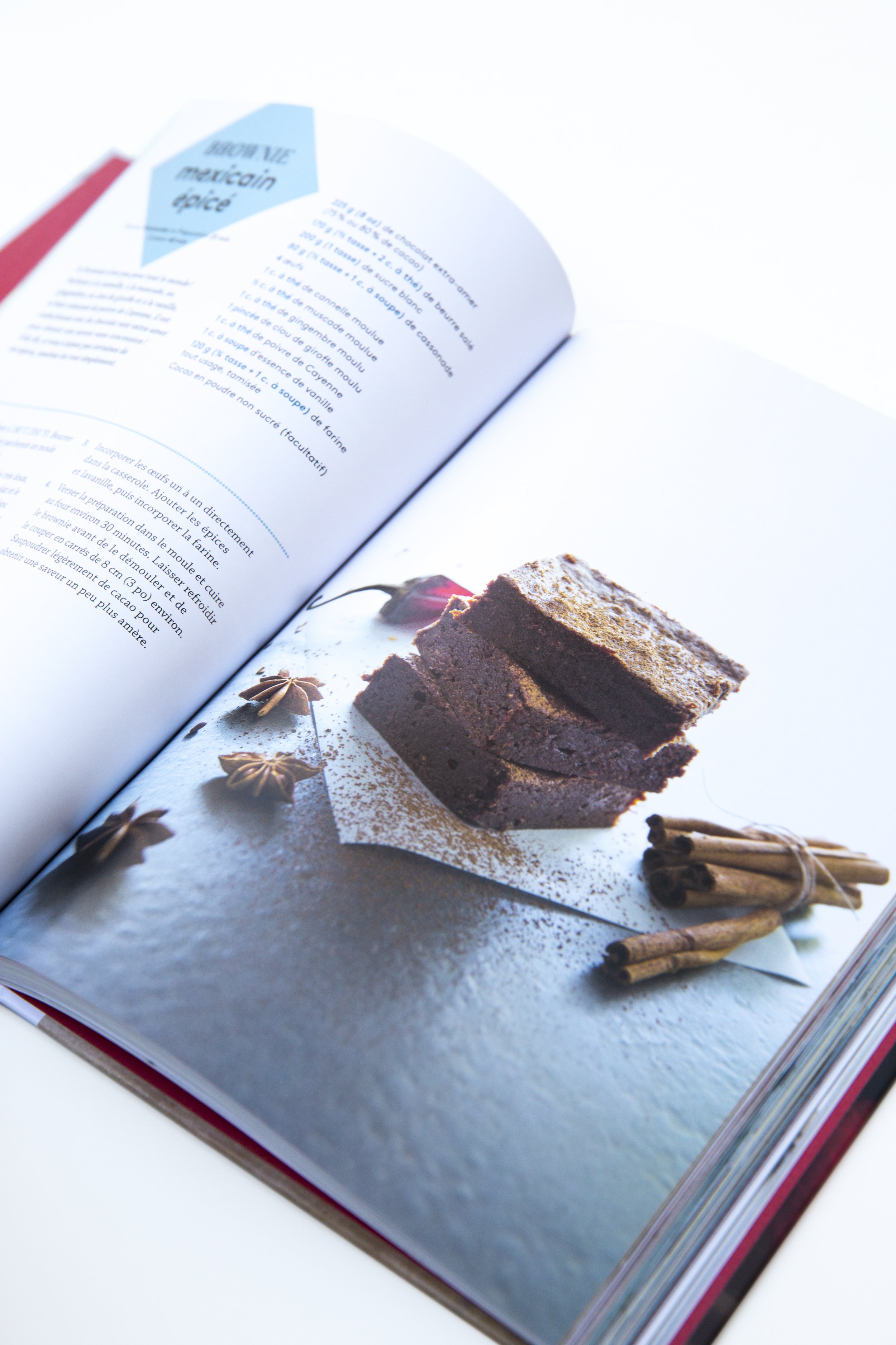 Brownie cookbook open on a photo of a spicy dark chocolate brownies