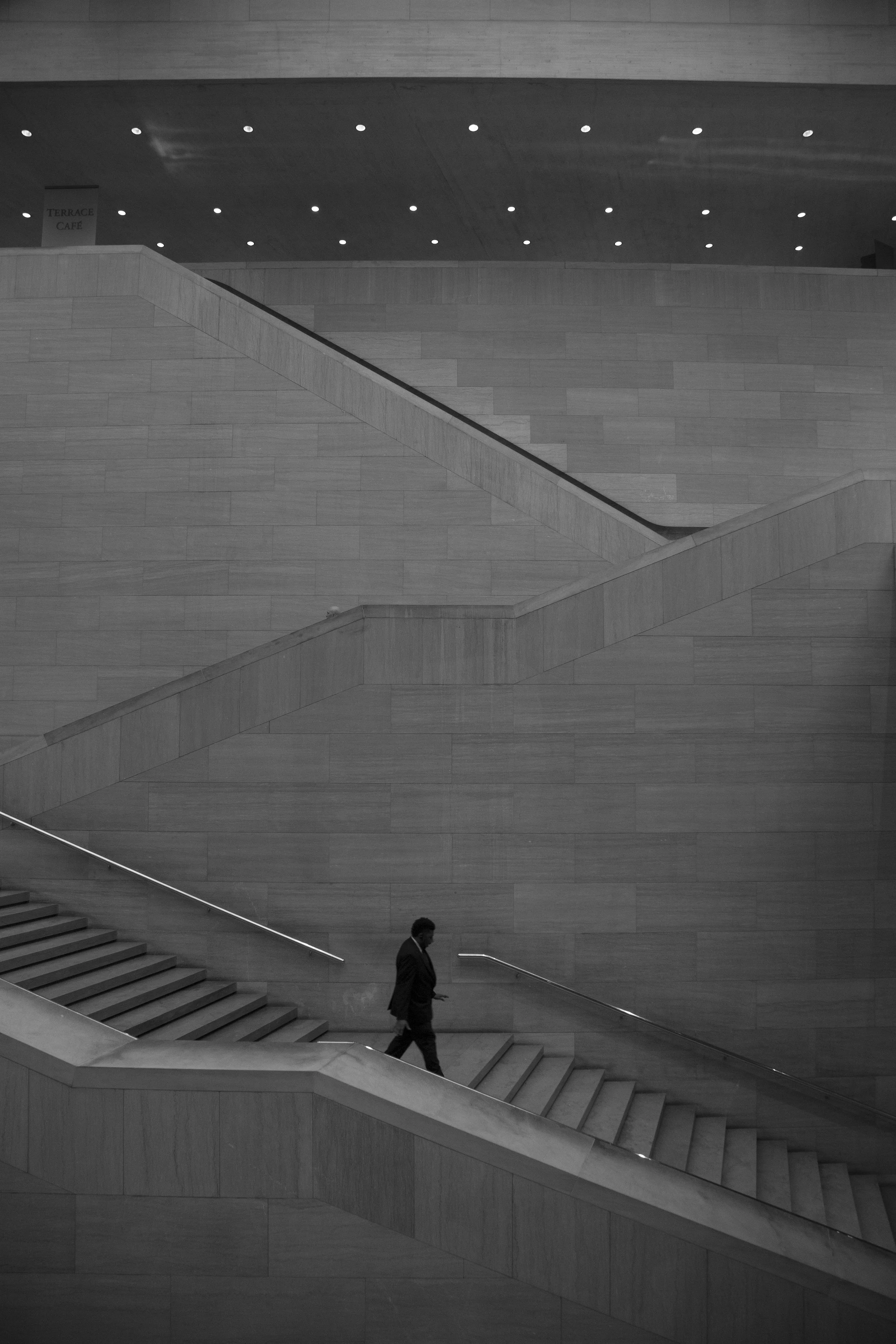 Stone staircase, architecture photography with human silhouette, beautiful art museum in black and white photo