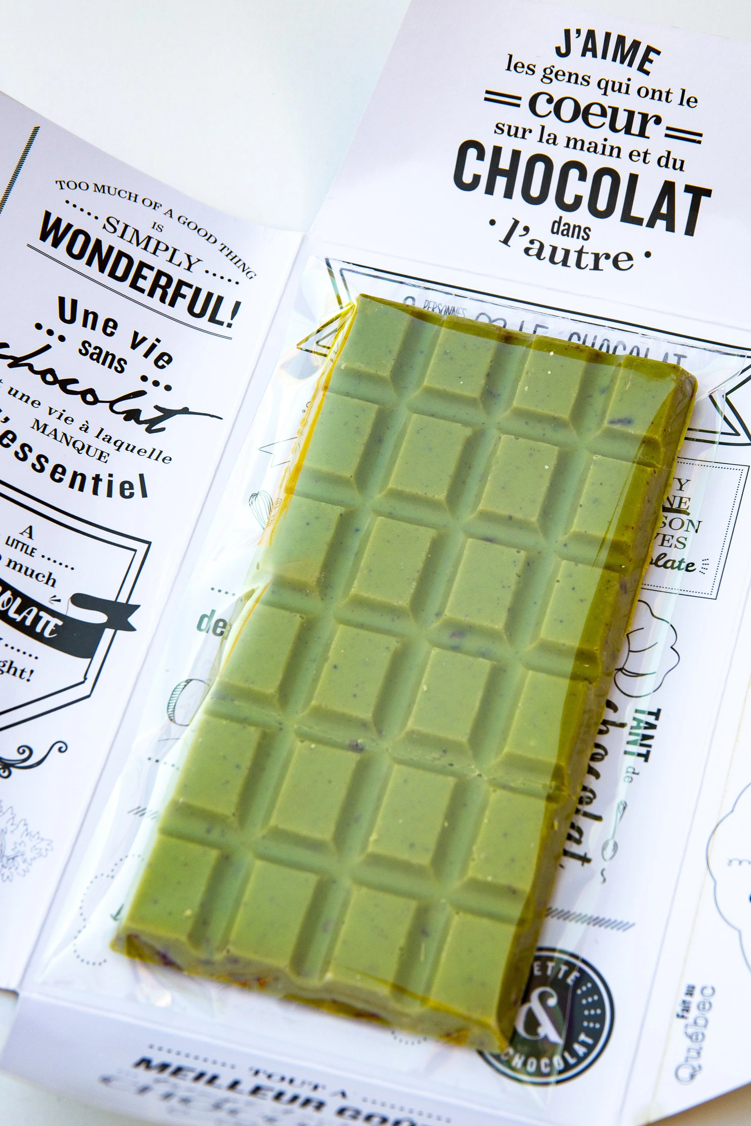 Green chocolate and matcha chocolate bar on white wrapper with fun quotes
