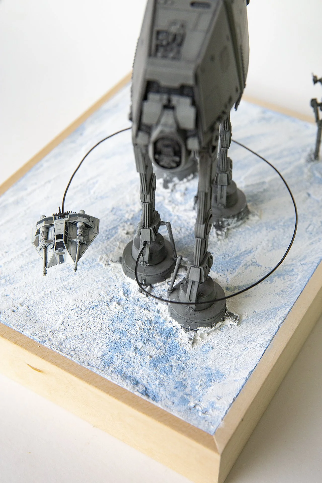 Star Wars snowspeeder tying the legs of an AT-AT, scale model diorama by Lionel May