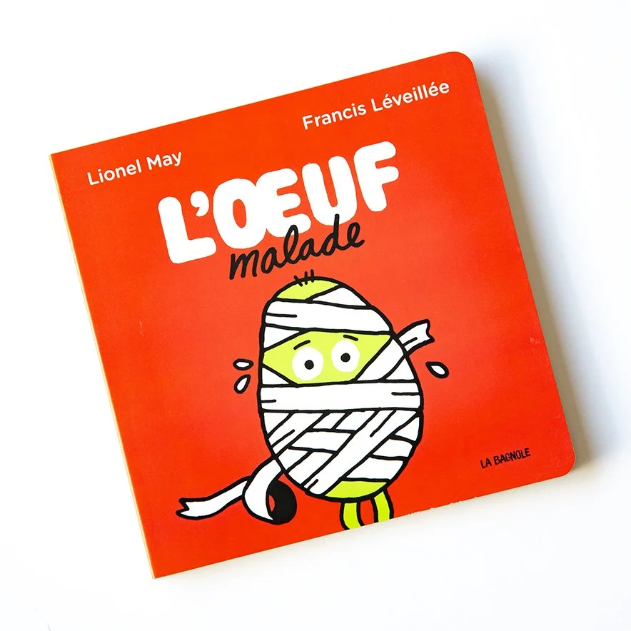 Front cover of picture book, brich red with cartoonish sick egg wrapped in bandages