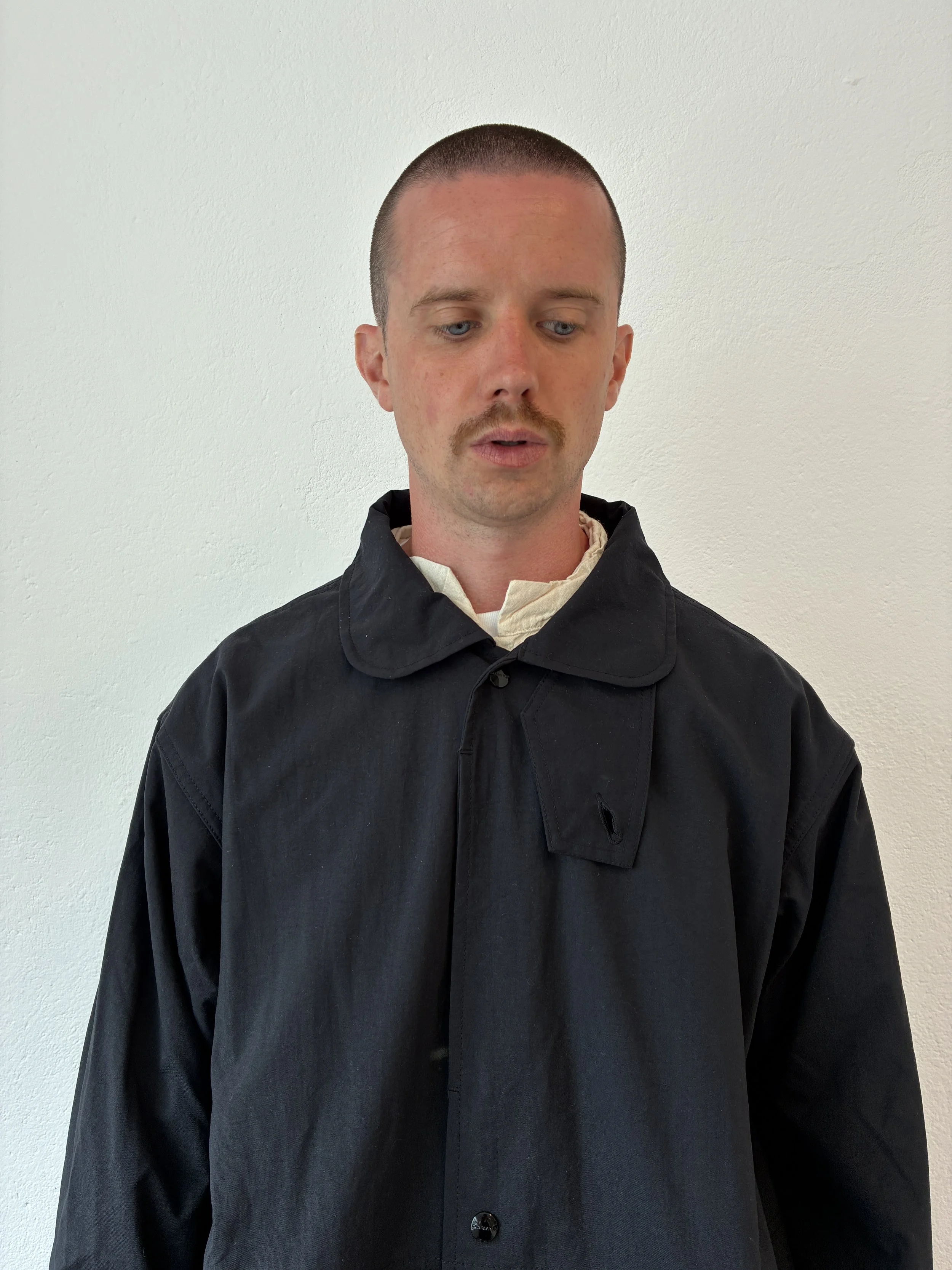 Closeup of Man wearing Black Sassafras Cultivator Coat