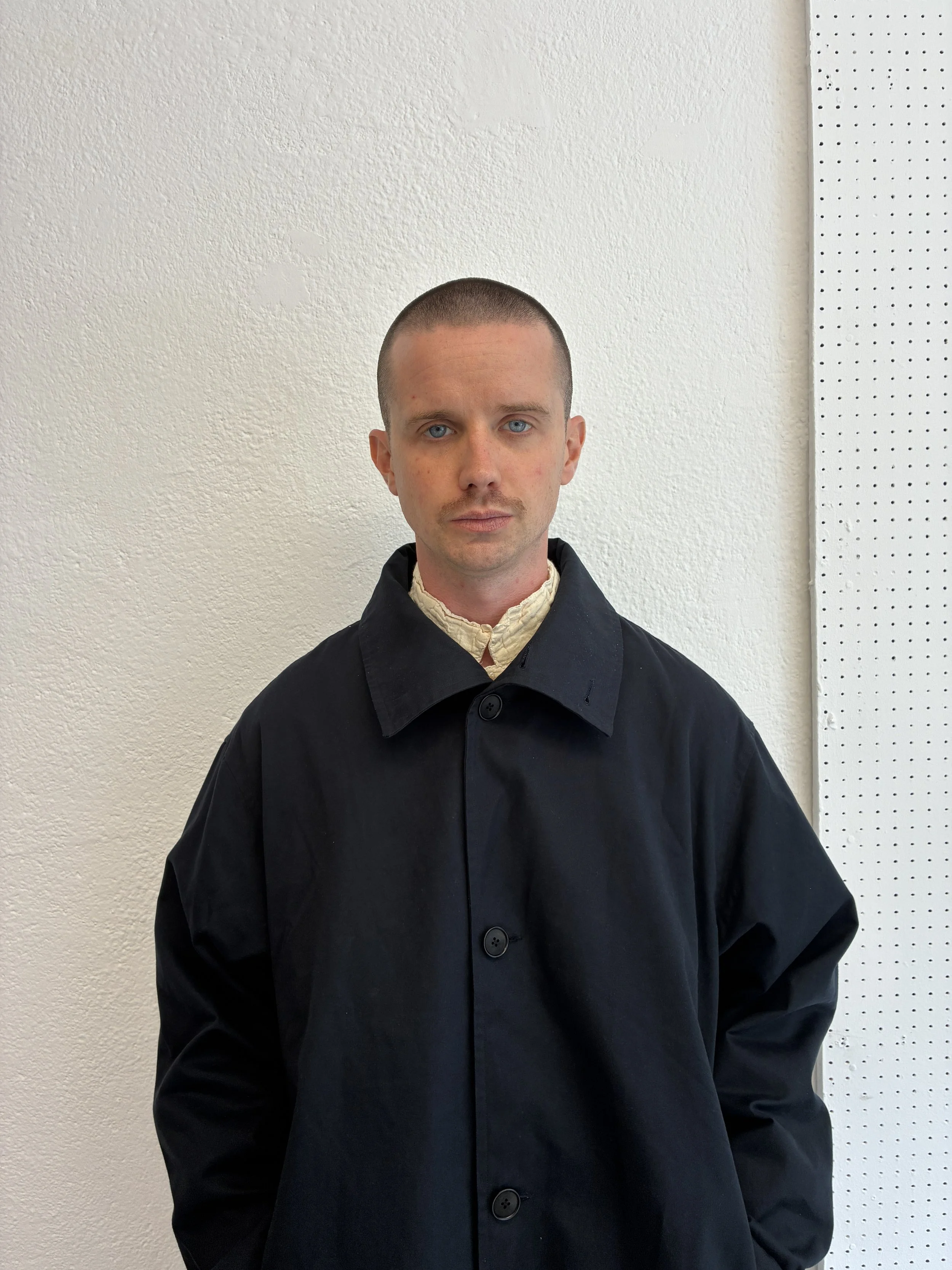 Closeup of man wearing Navy De Dam Foundation Cotton Gabardine Trench Coat