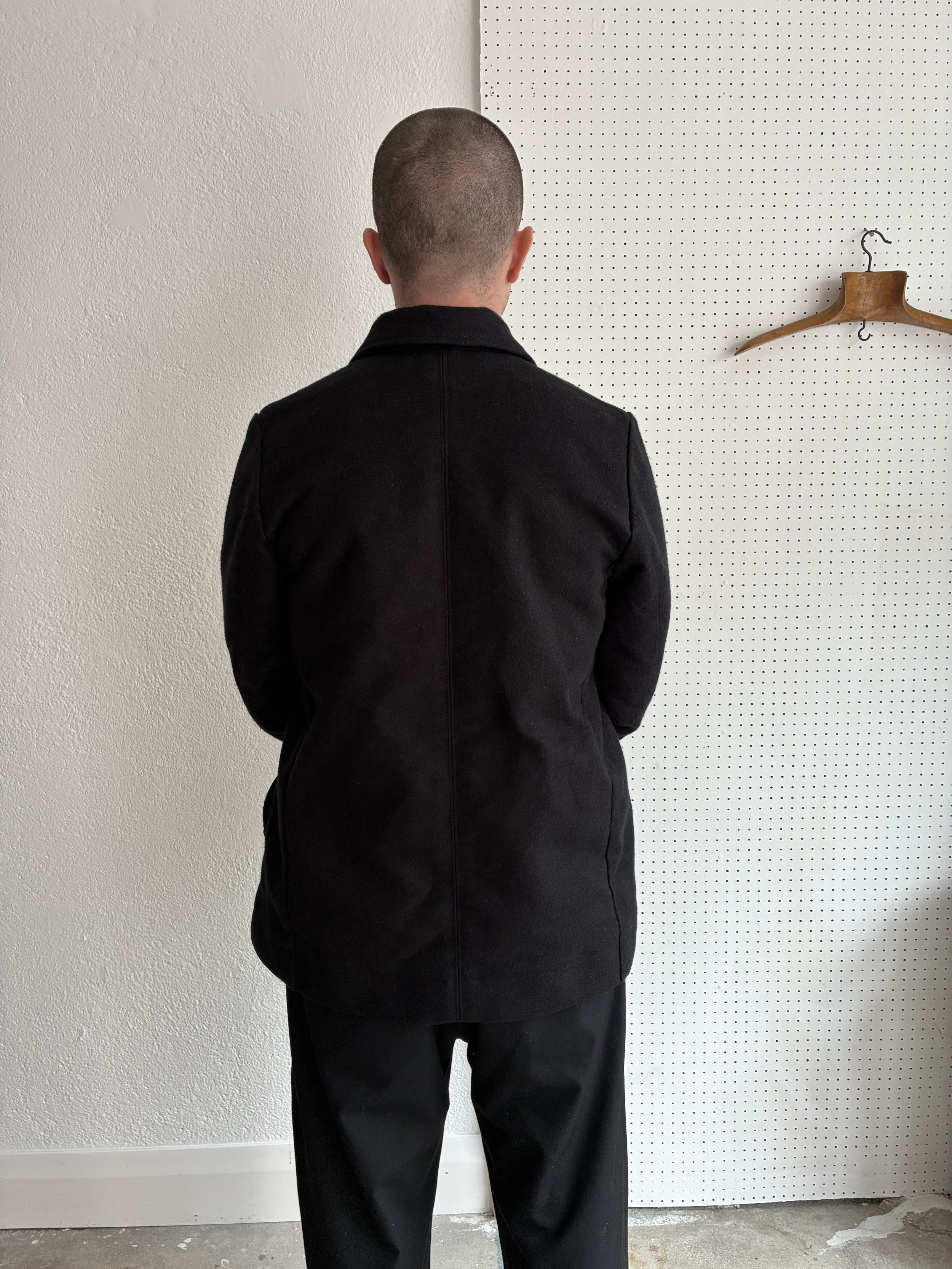 Model wears Black Frank Leder Deutschleder Jacket, back profile