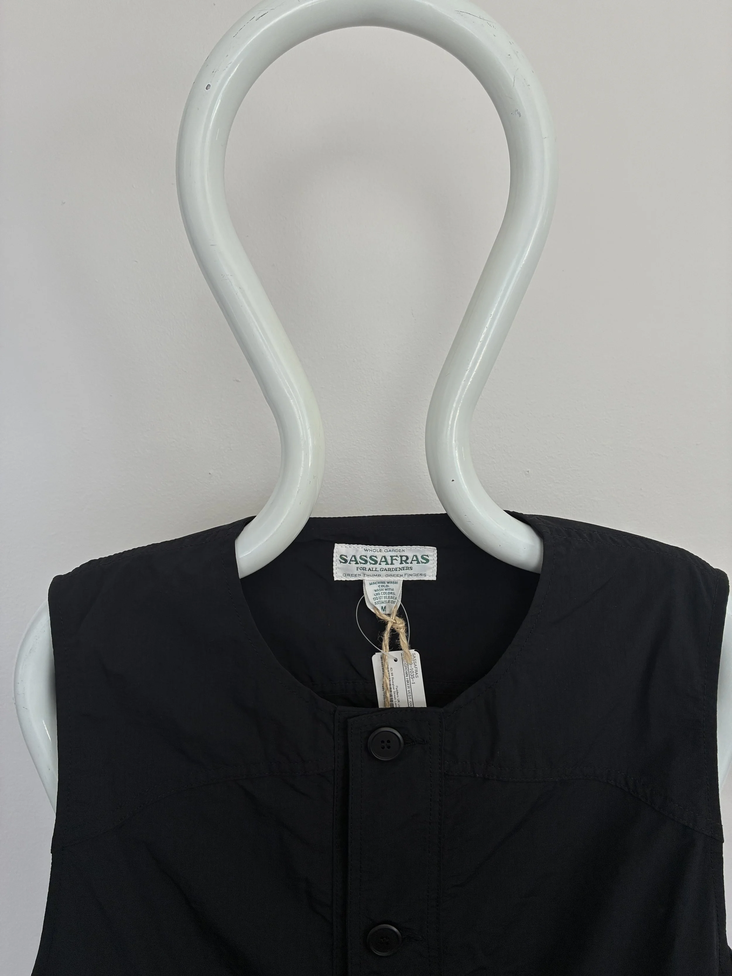 Closeup of collar of Black Sassafras Overgrown Hiker Vest on mannequin