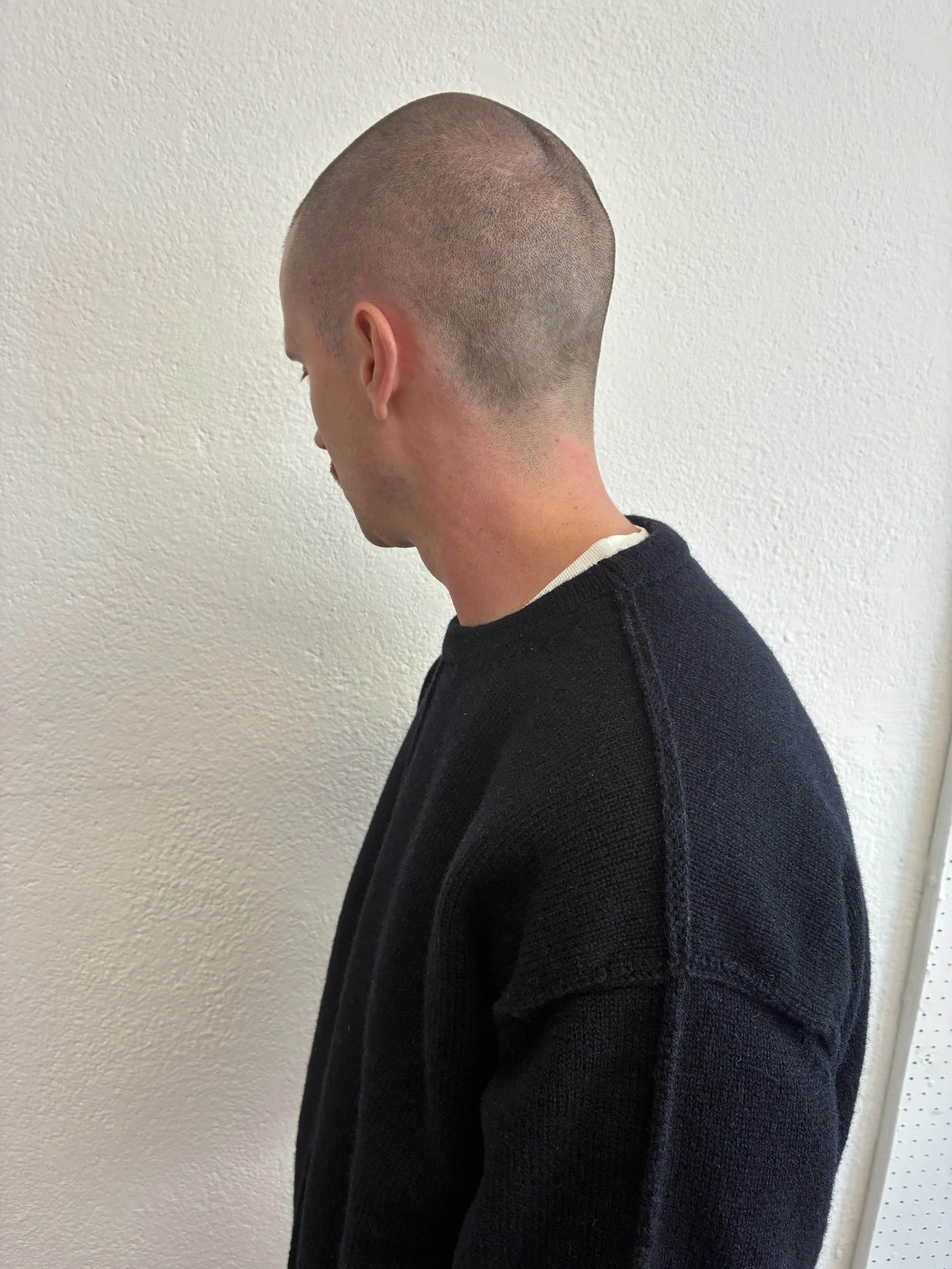 Closeup of man wearing the Navy Tender Co Type 719 Butterfly Jumper
