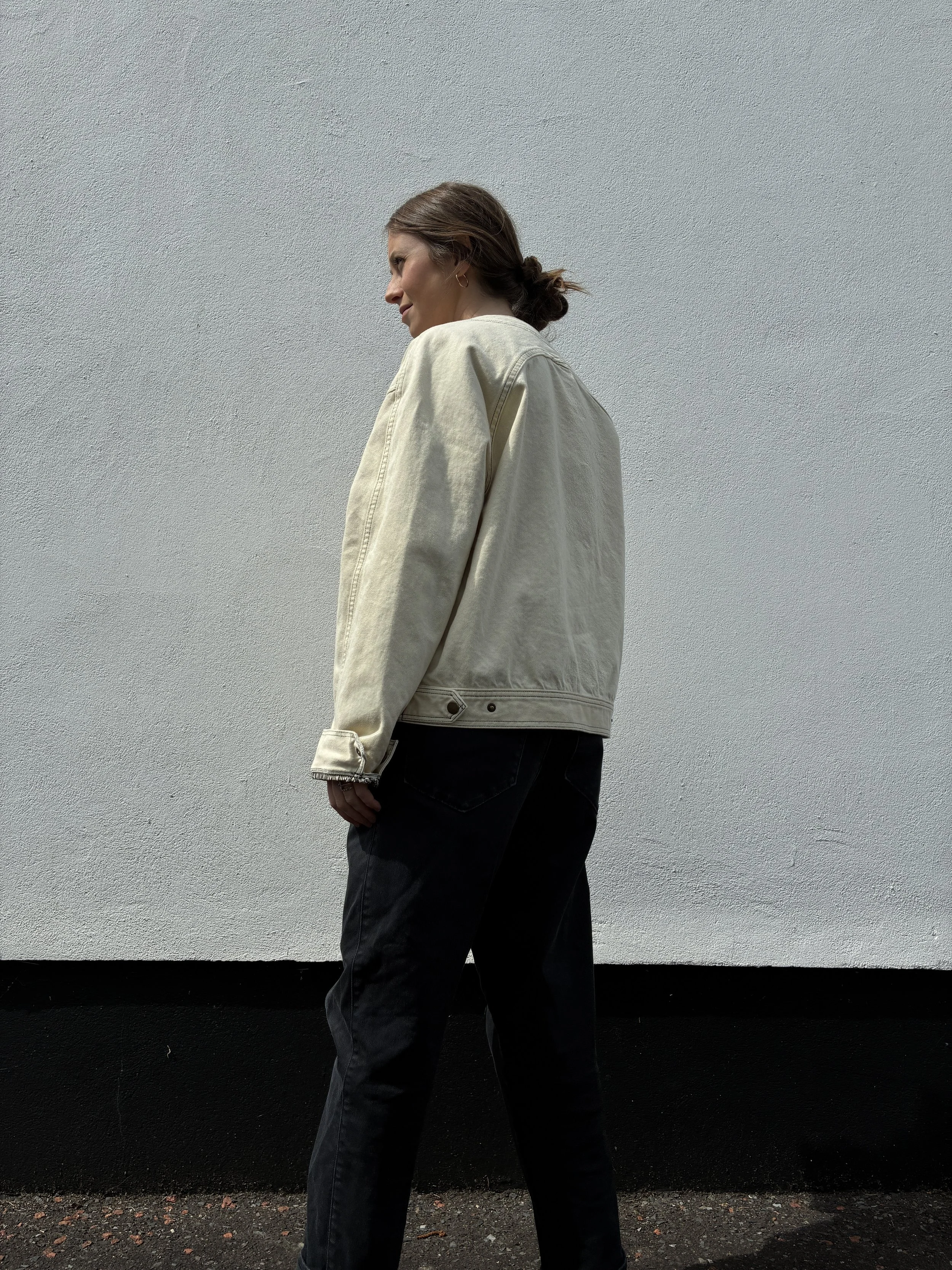 Side profile of woman outside wearing Working Skewed yeast jacket