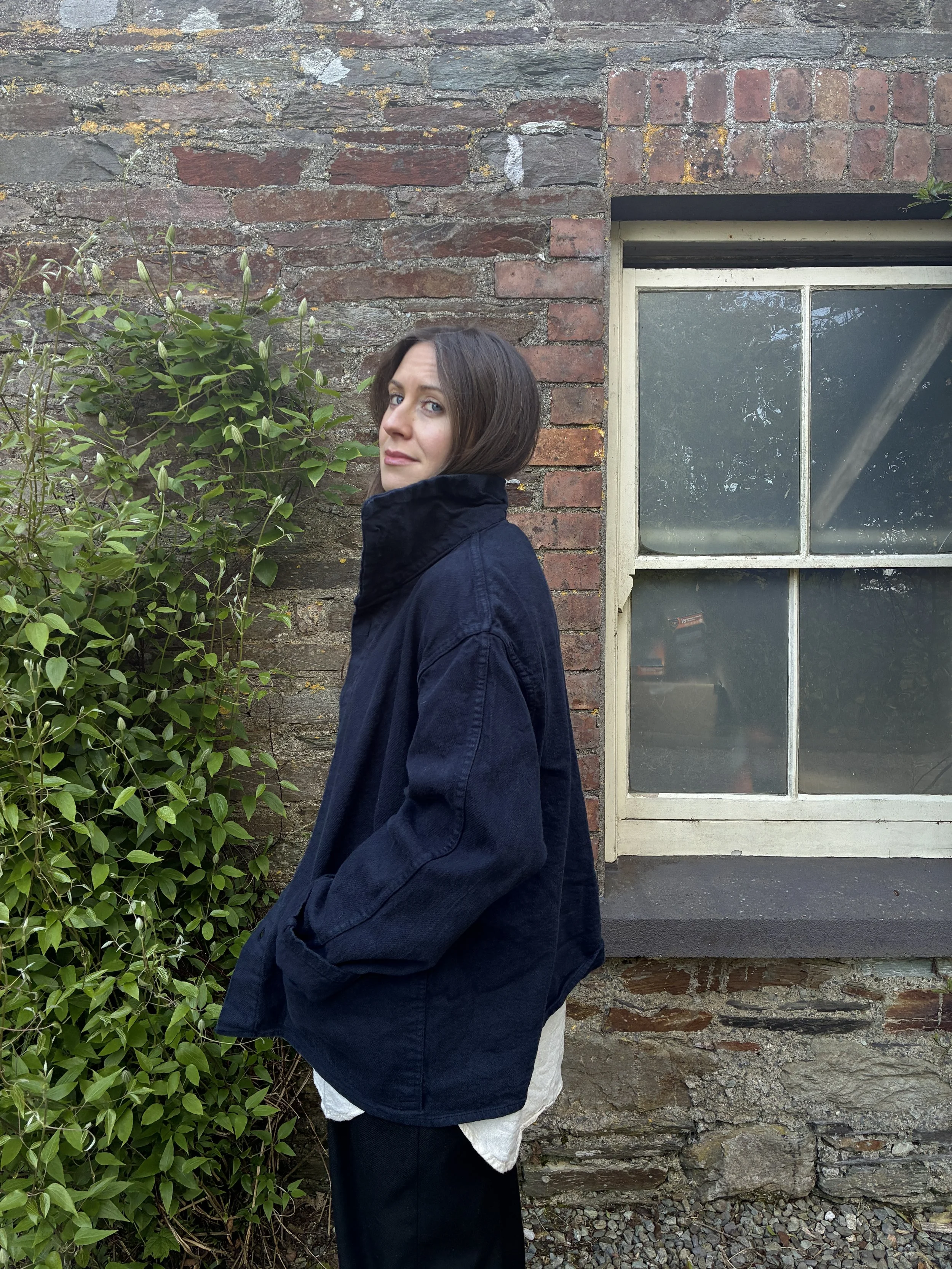 Woman standing side on in Tender Hadal Blue 931 Scout Jacket