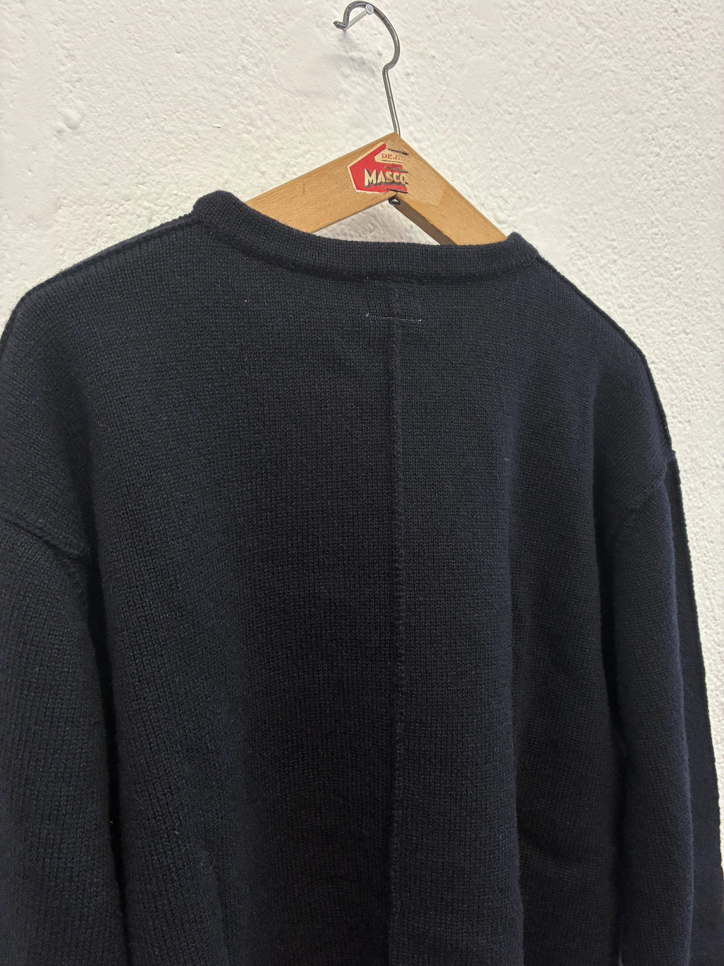 Closeup of back of Navy Tender Co Type 719 Butterfly Jumper on hanger