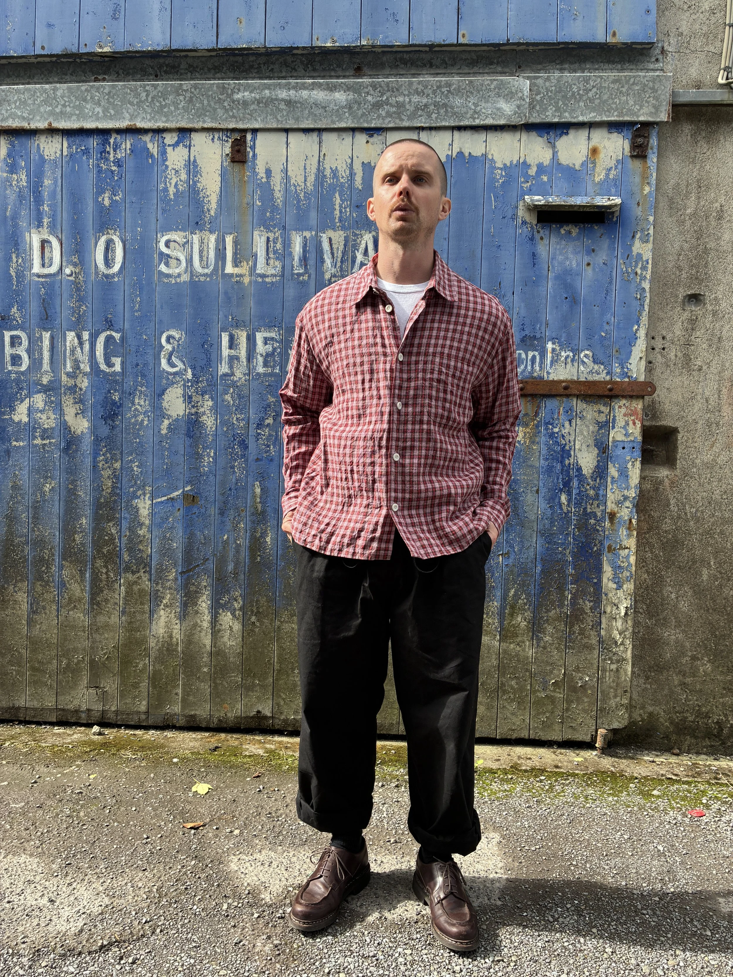 Man wearing Conkers Sunrise Relaxed Farmer Shirt in front of blue shutter
