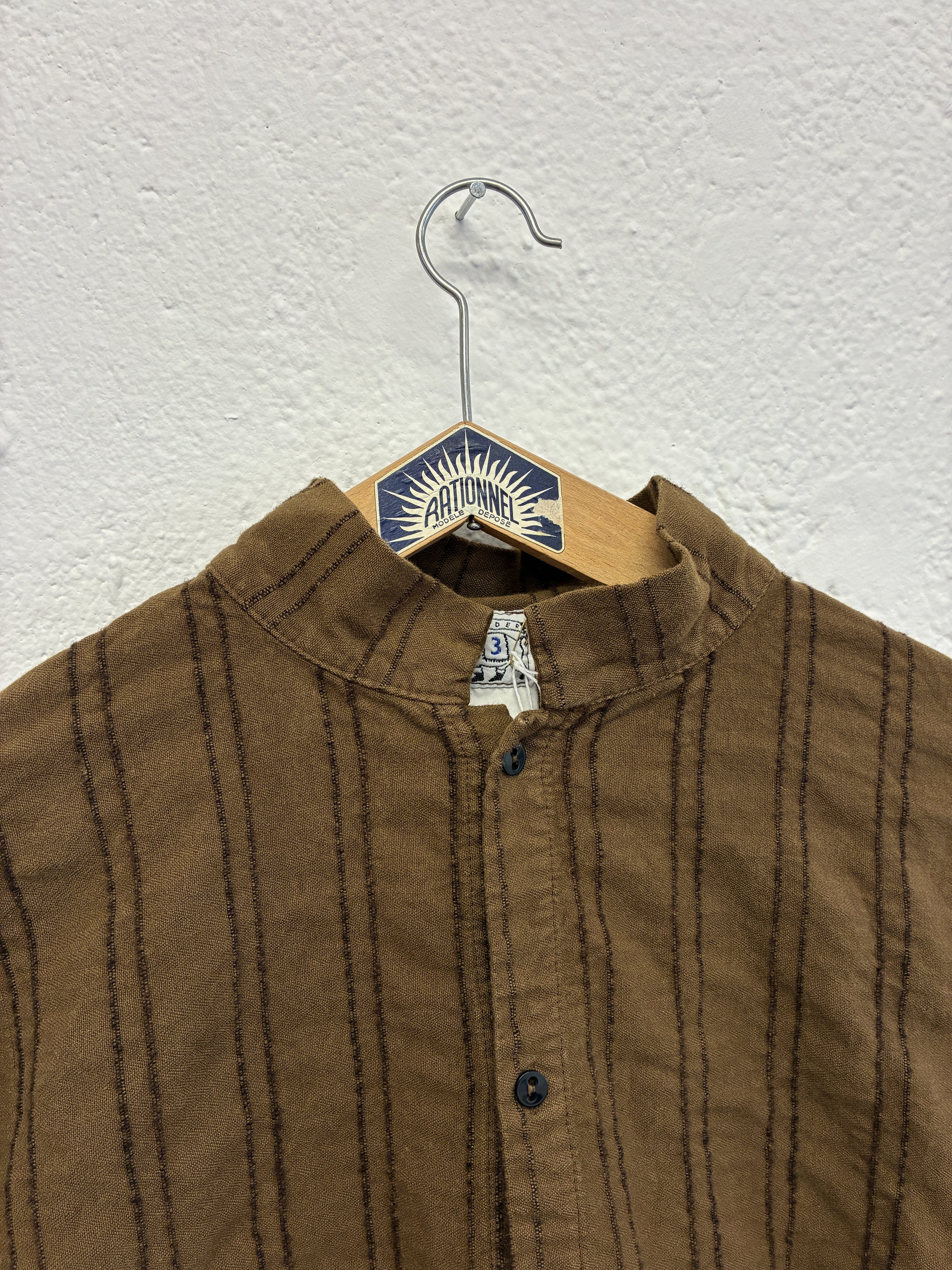 Closeup of collar of Brown Tender Co Type 486 Burro Shirt on hanger