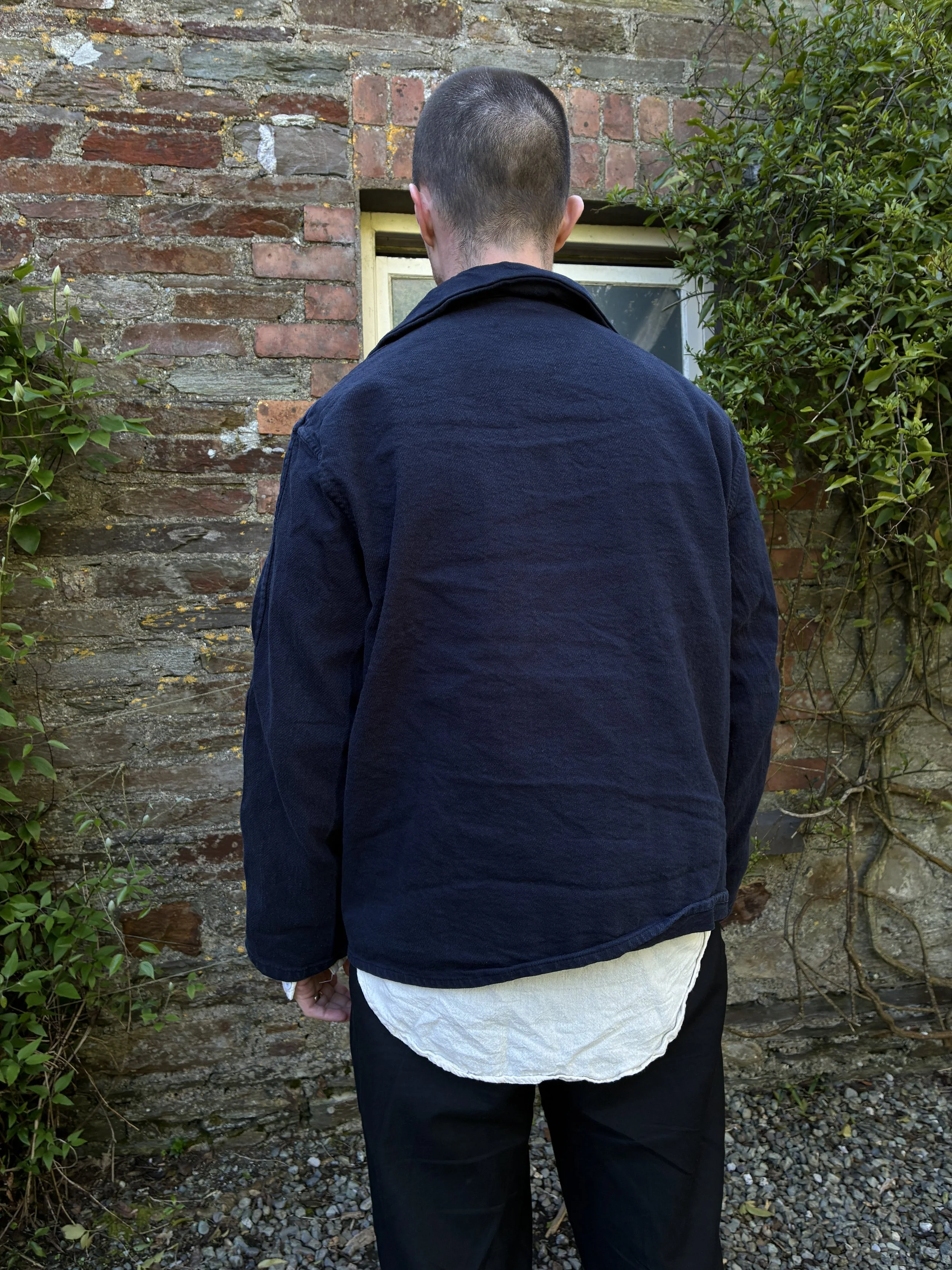 Man showing the back of the Tender Hadal Blue 931 Scout Jacket