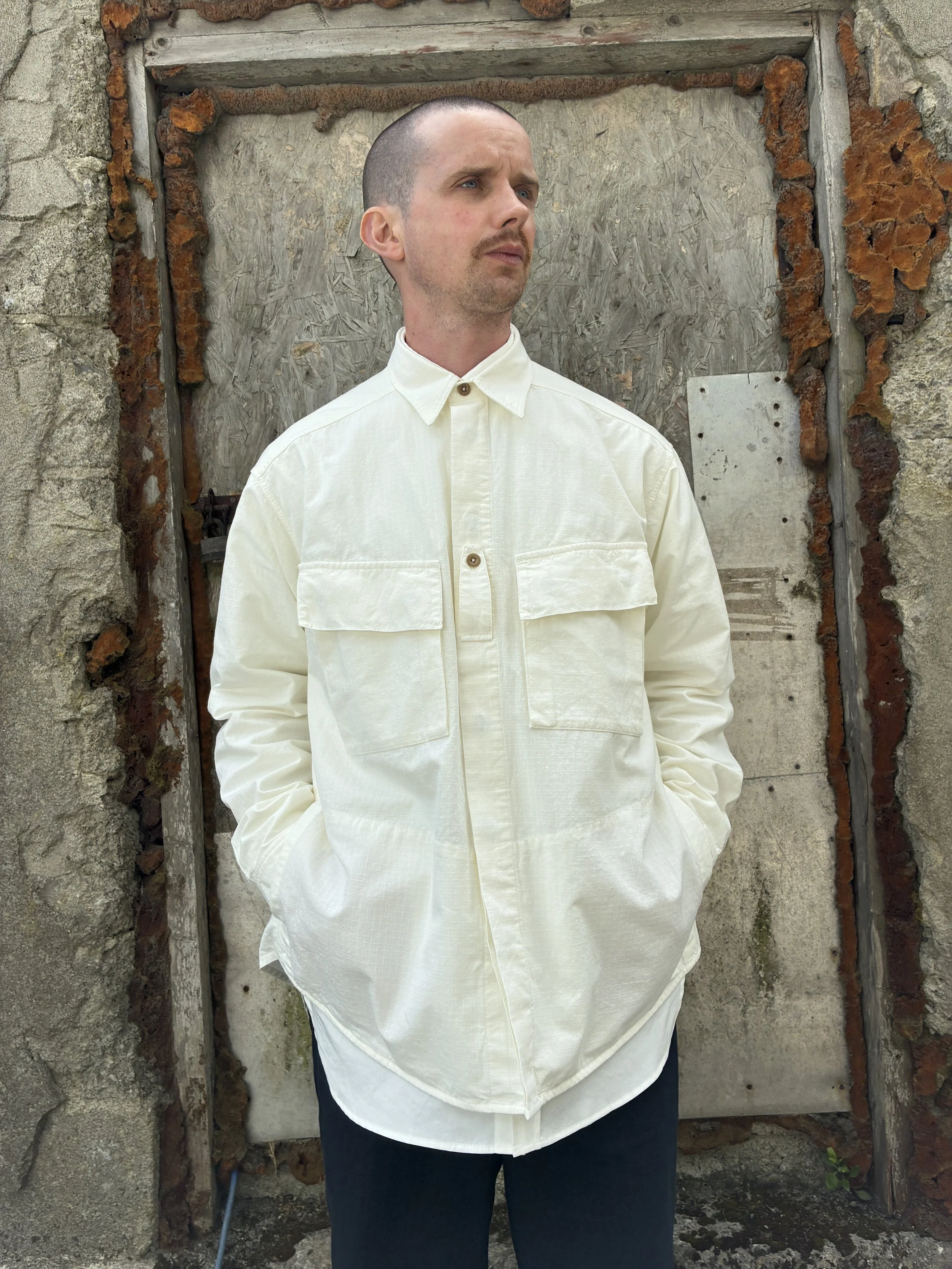 Man in front of wall wearing Off-White Ecru 1st PAT-RN Sumatra Overshirt