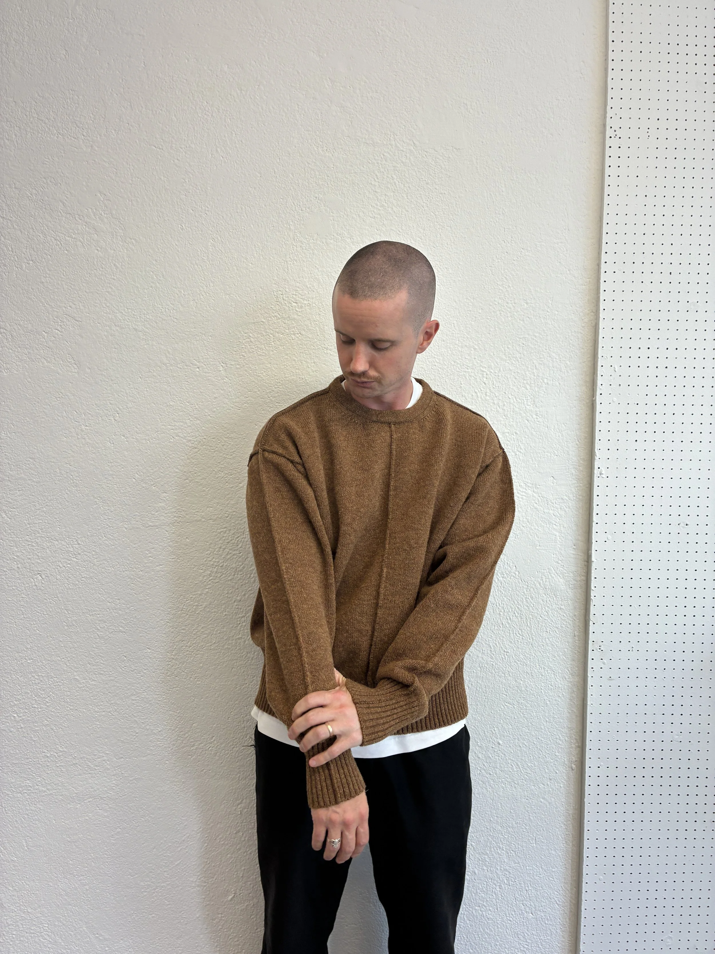 Closeup of man in front of wall wearing Brown Tender Co Type 719 Butterfly Jumper