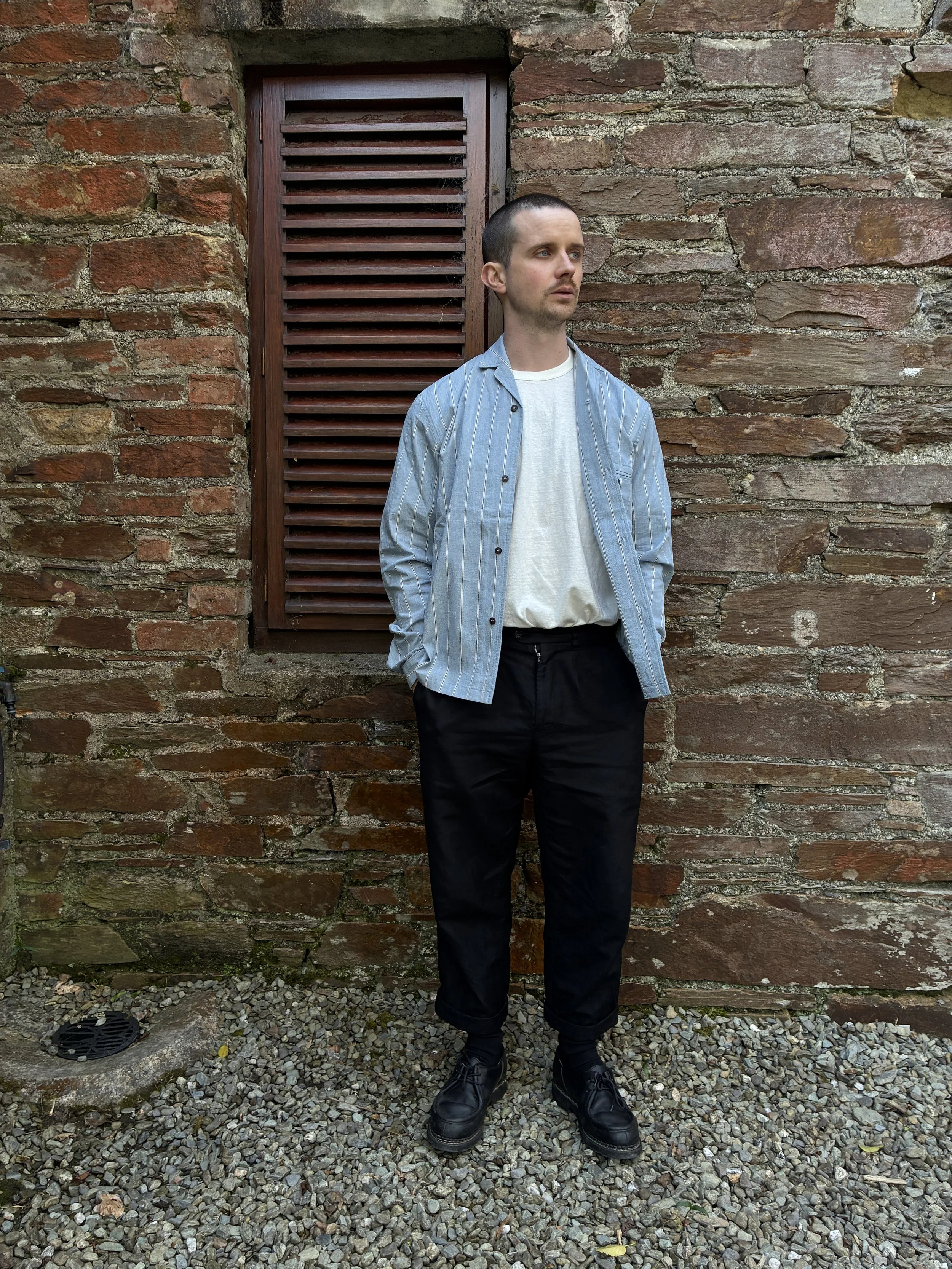 Man in front of wall wearing Frank Leder Japanese Cotton Blue Striped Shirt