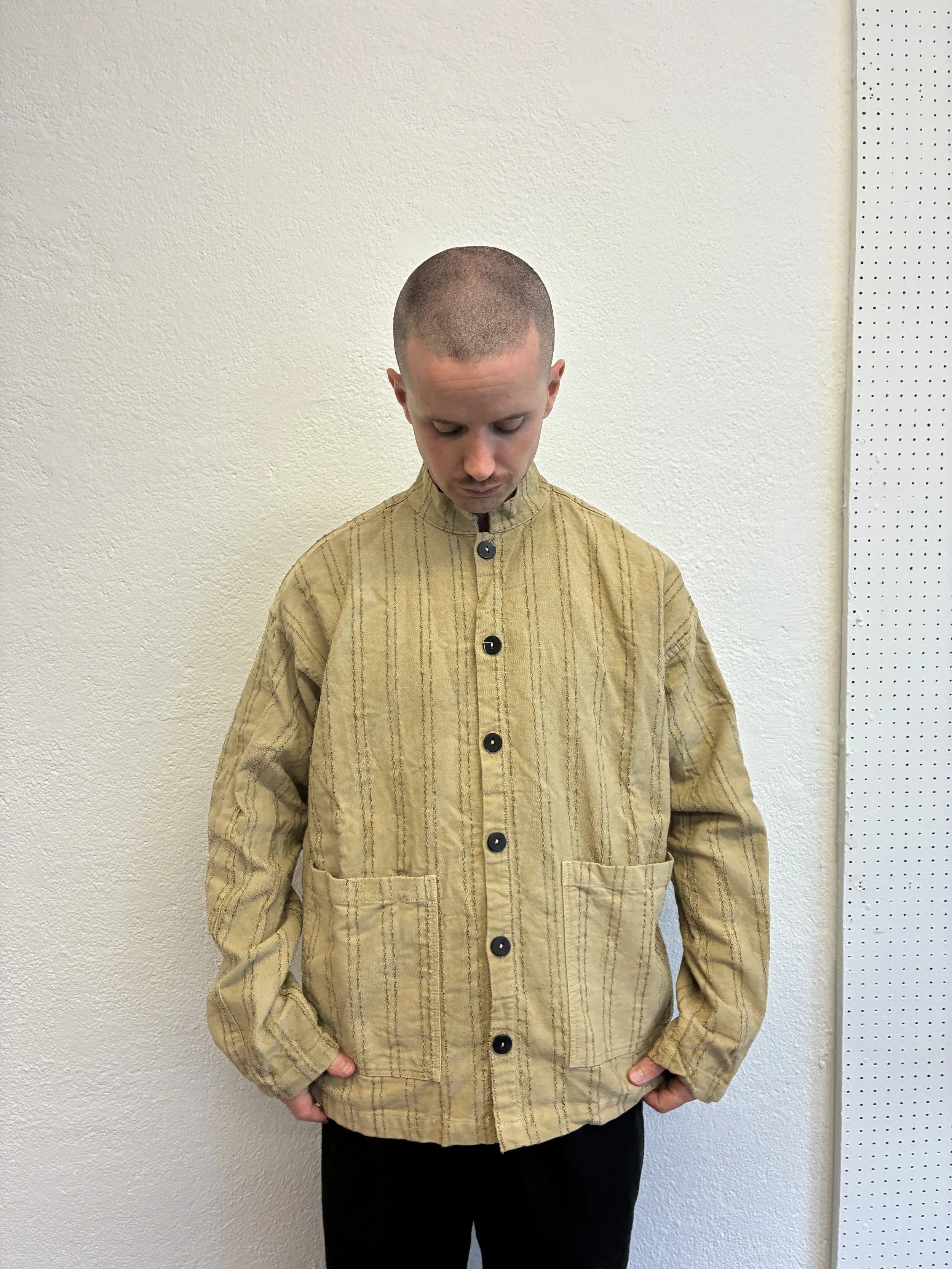 Man wearing  Drab Weld Tender Co Type 485 Isosceles Shirt in front of white wall buttoned up