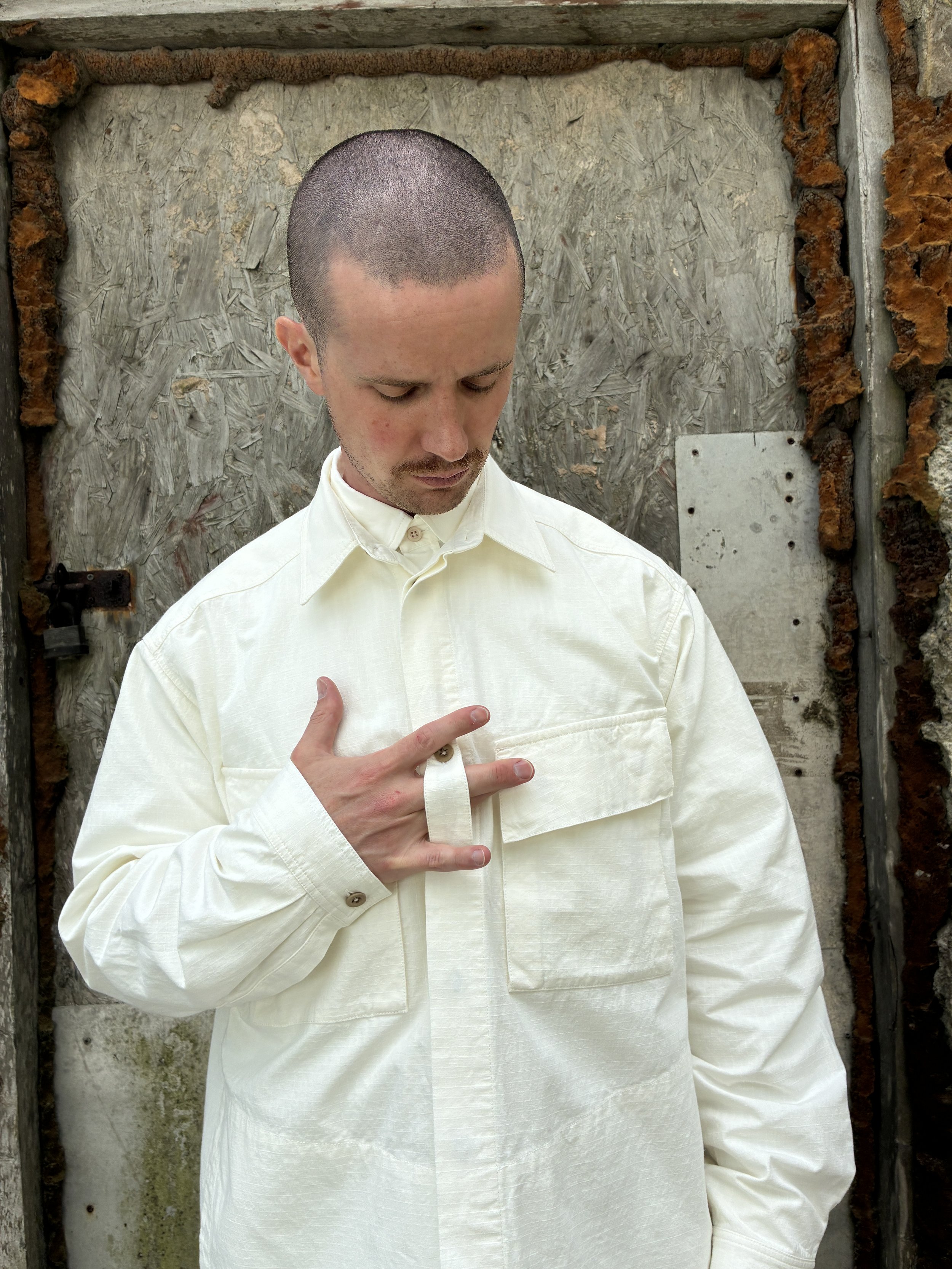 Man in front of wall wearing Off-White Ecru 1st PAT-RN Sumatra Overshirt