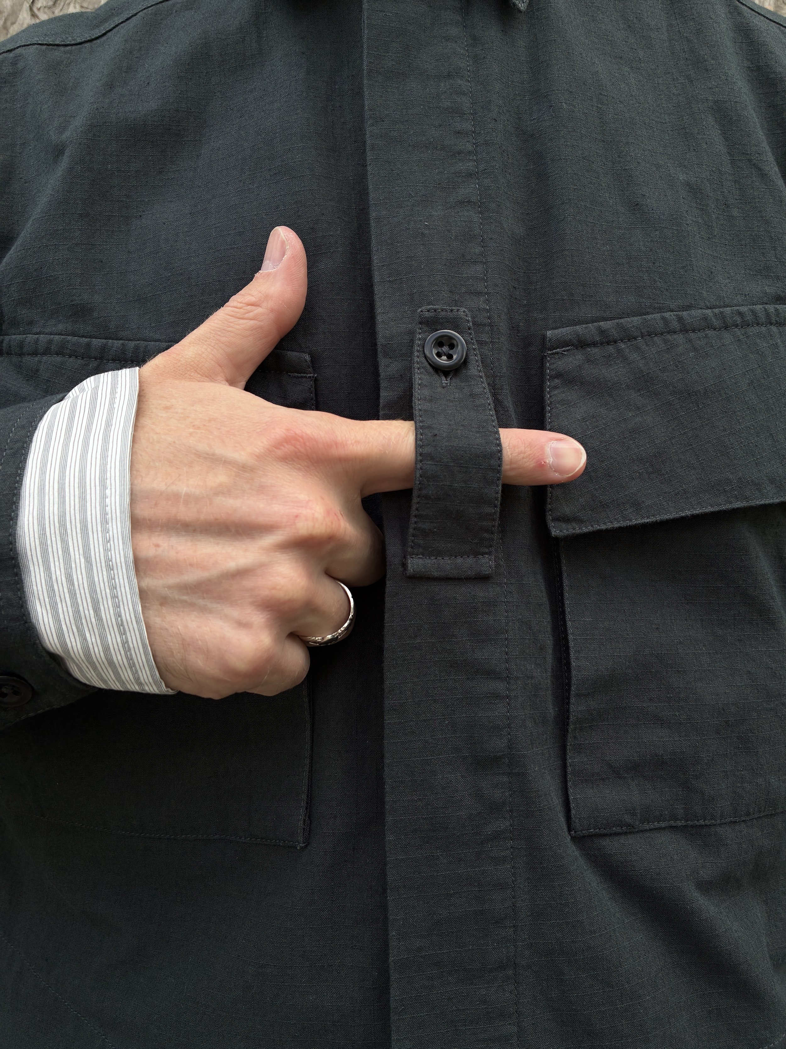 Closeup of hand showing detail of 1st PAT-RN Sumatra Charcoal Overshirt