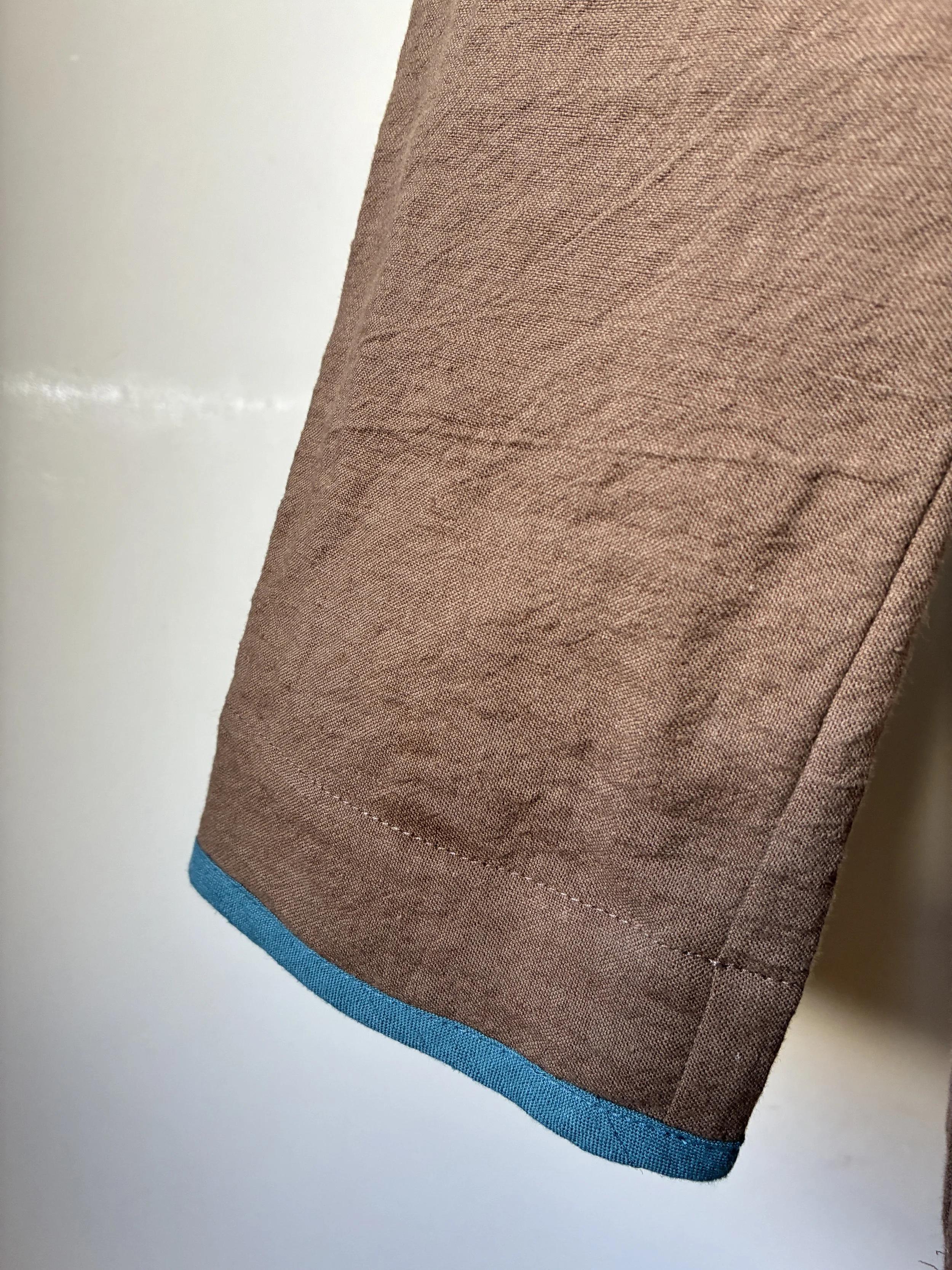 Closeup of cuff of Frank Leder Linen Cotton Brown Teal Jacket on mannequin