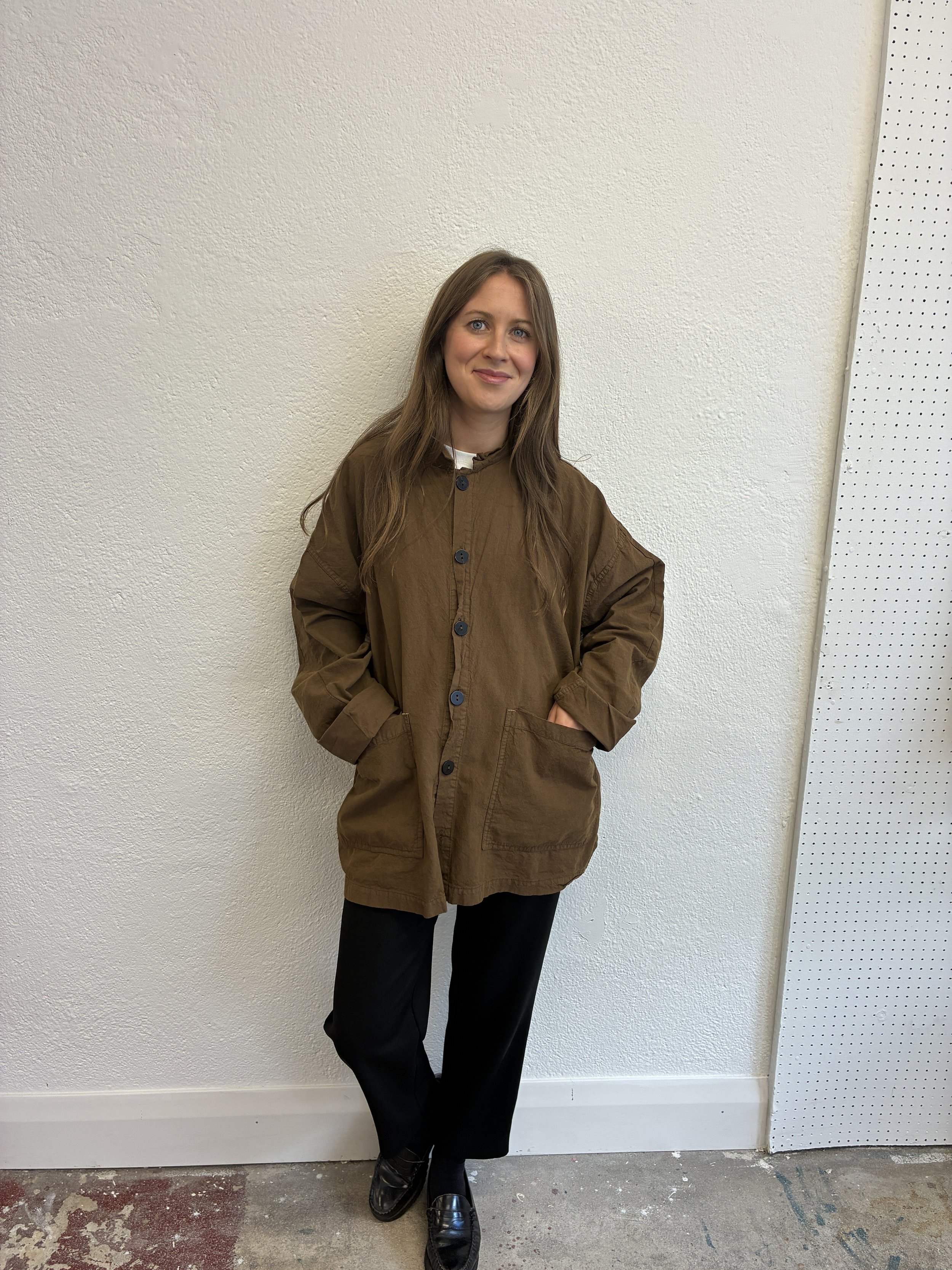 Woman in front of wall wearing Tender Co Type 485 Isosceles Brown Hat Shirt