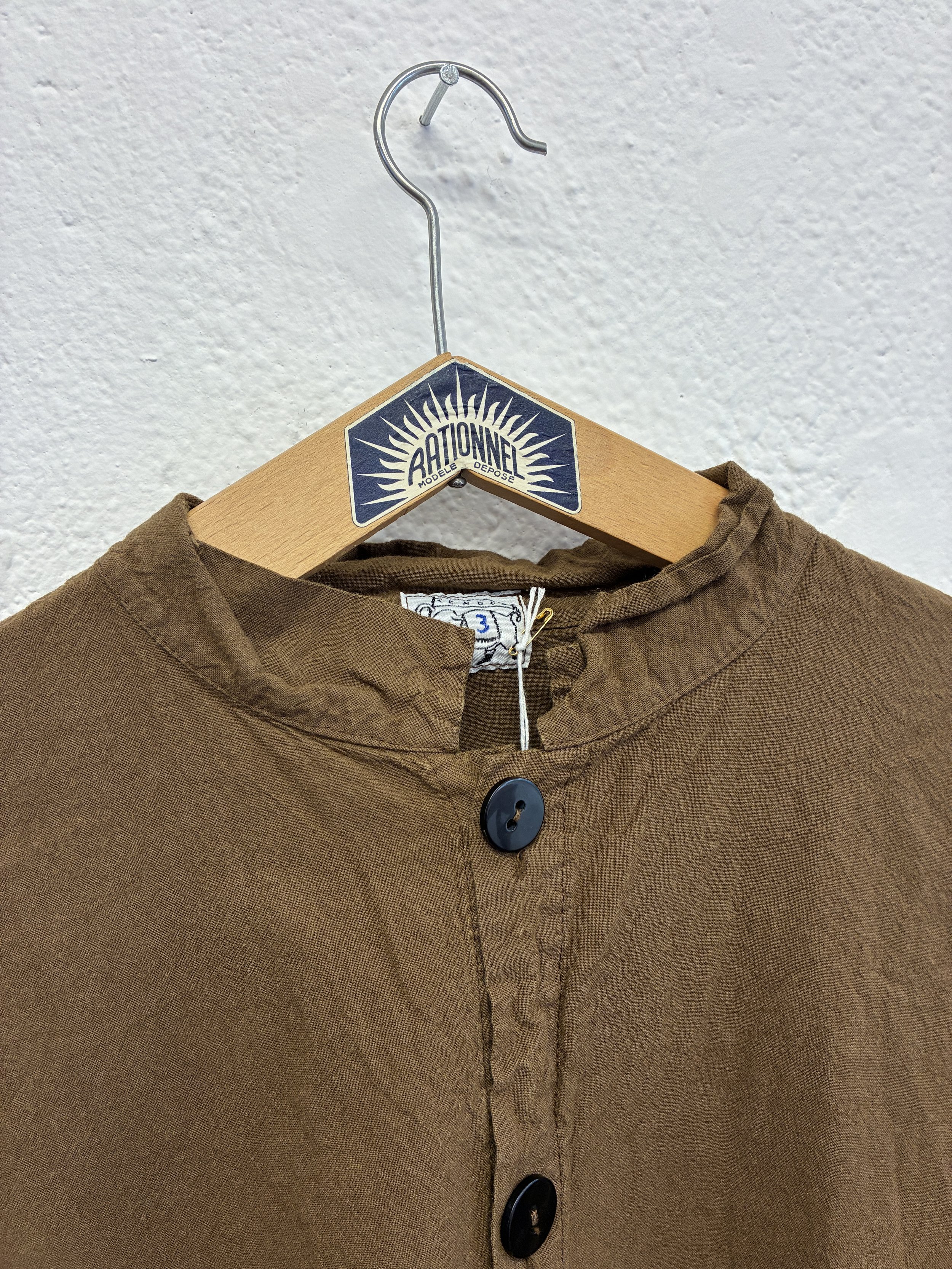 Closeup of collar of Tender Co Type 485 Isosceles Brown Hat Shirt  on hanger