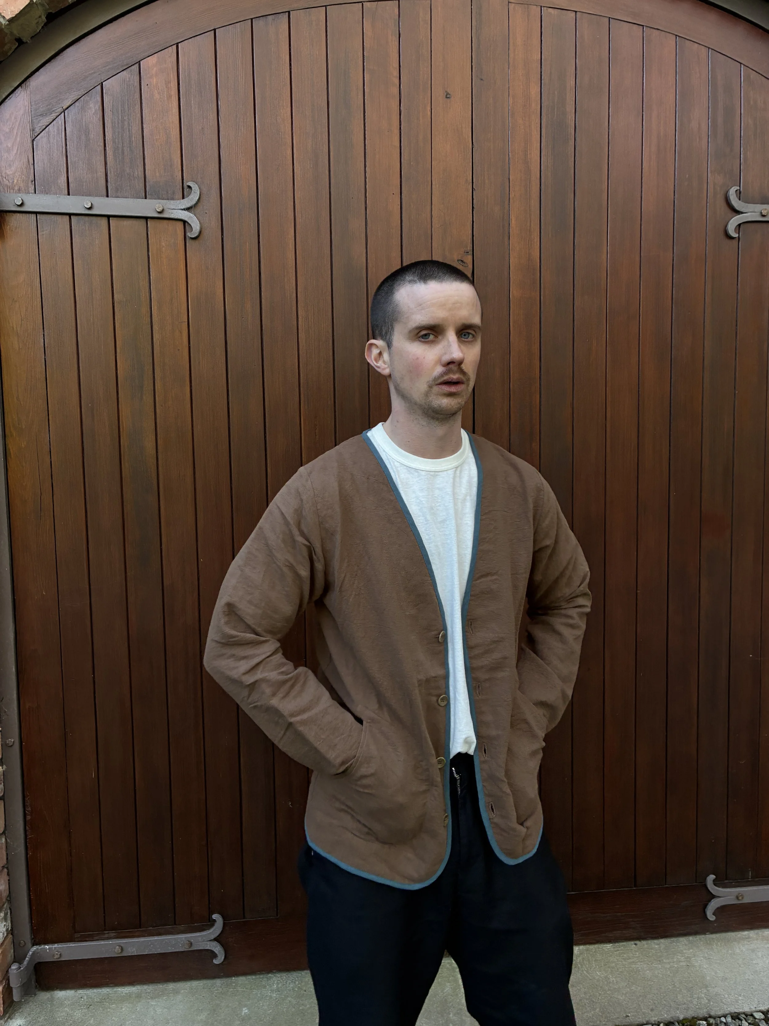 Man in front of door wearing Frank Leder Linen Cotton Brown Teal Jacket