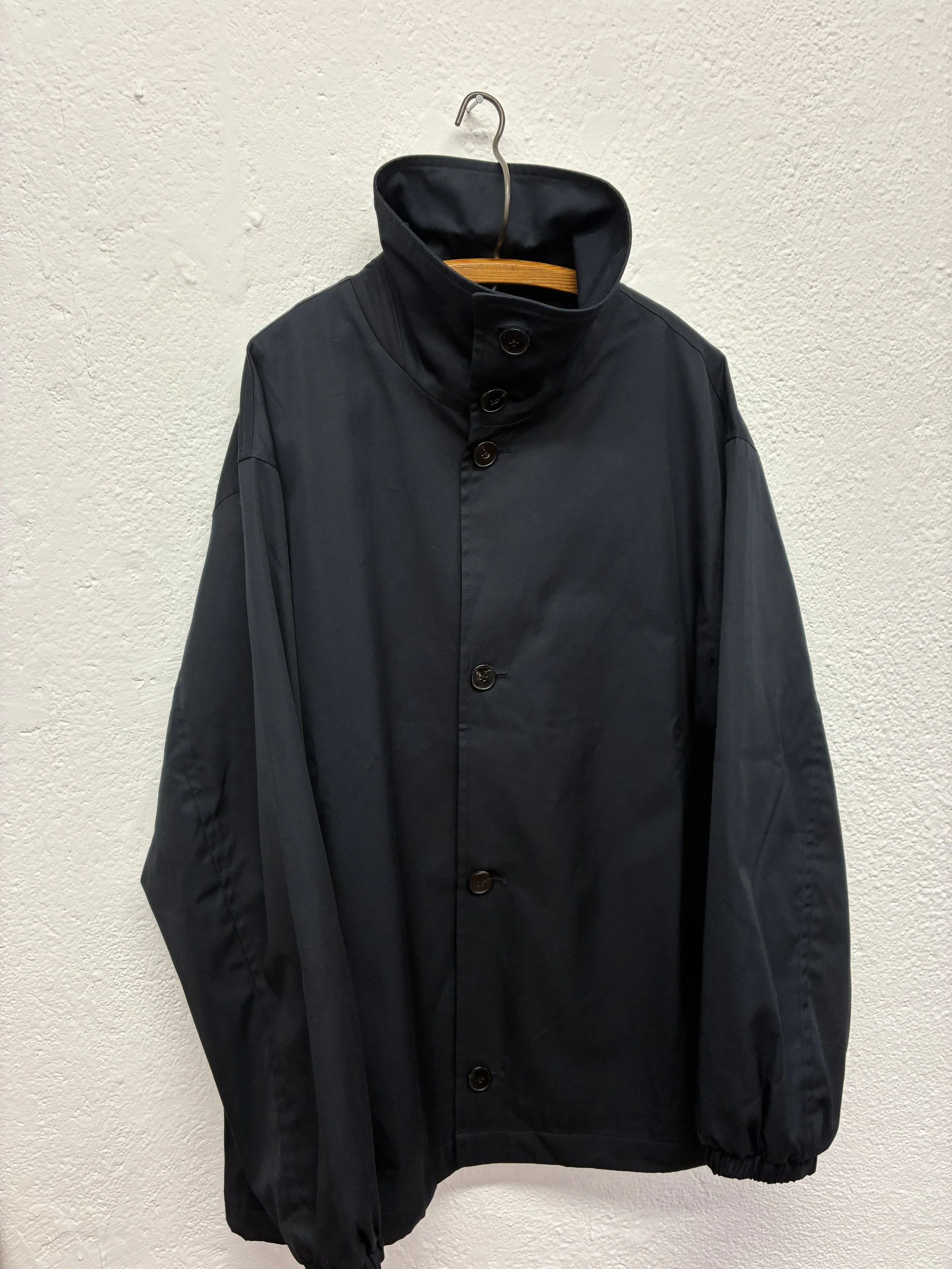Navy De Dam Foundation Cotton Gabardine Jacket on hanger buttoned up