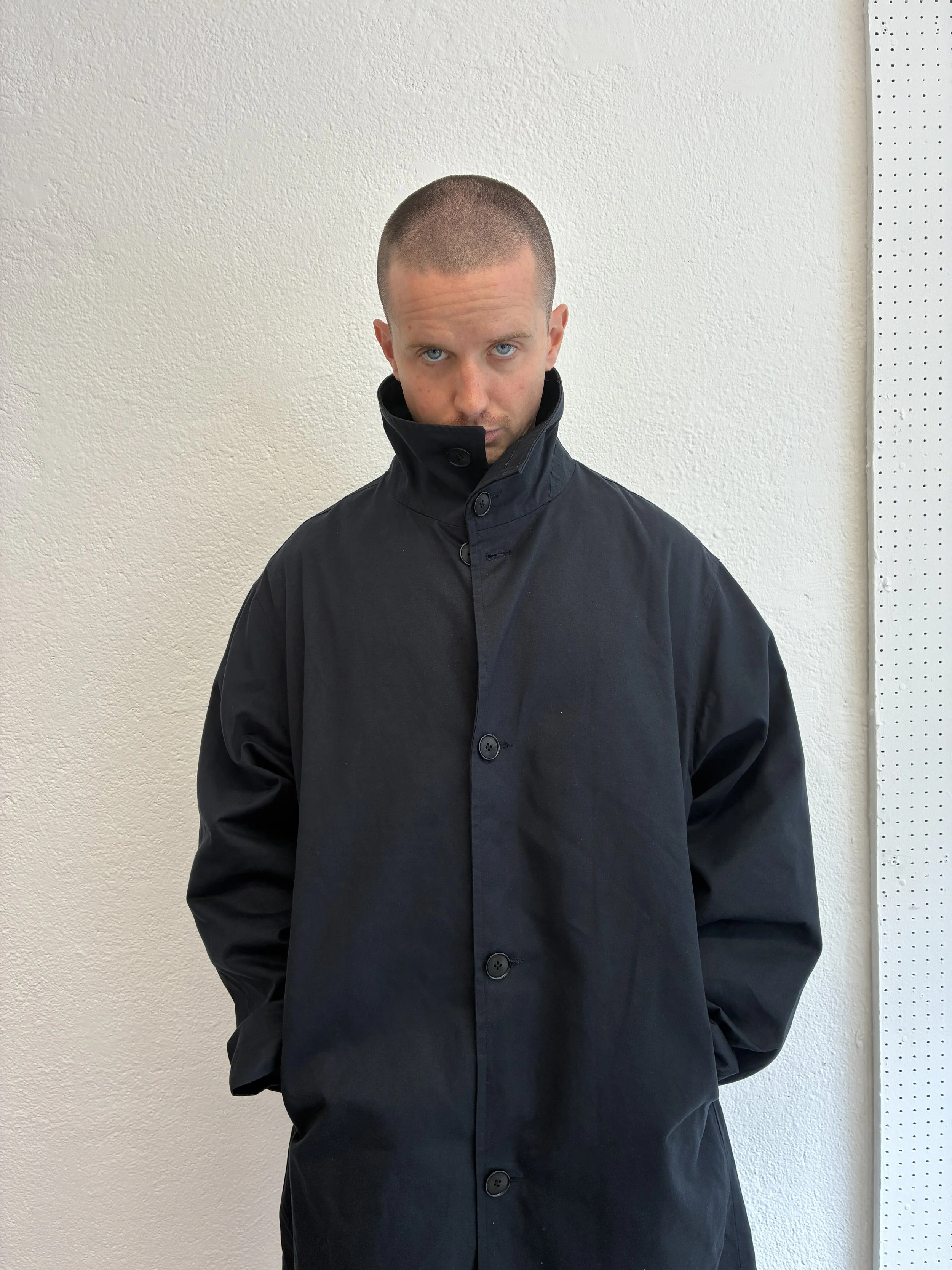 Closeup of Man wearing Navy De Dam Foundation Cotton Gabardine Trench Coat