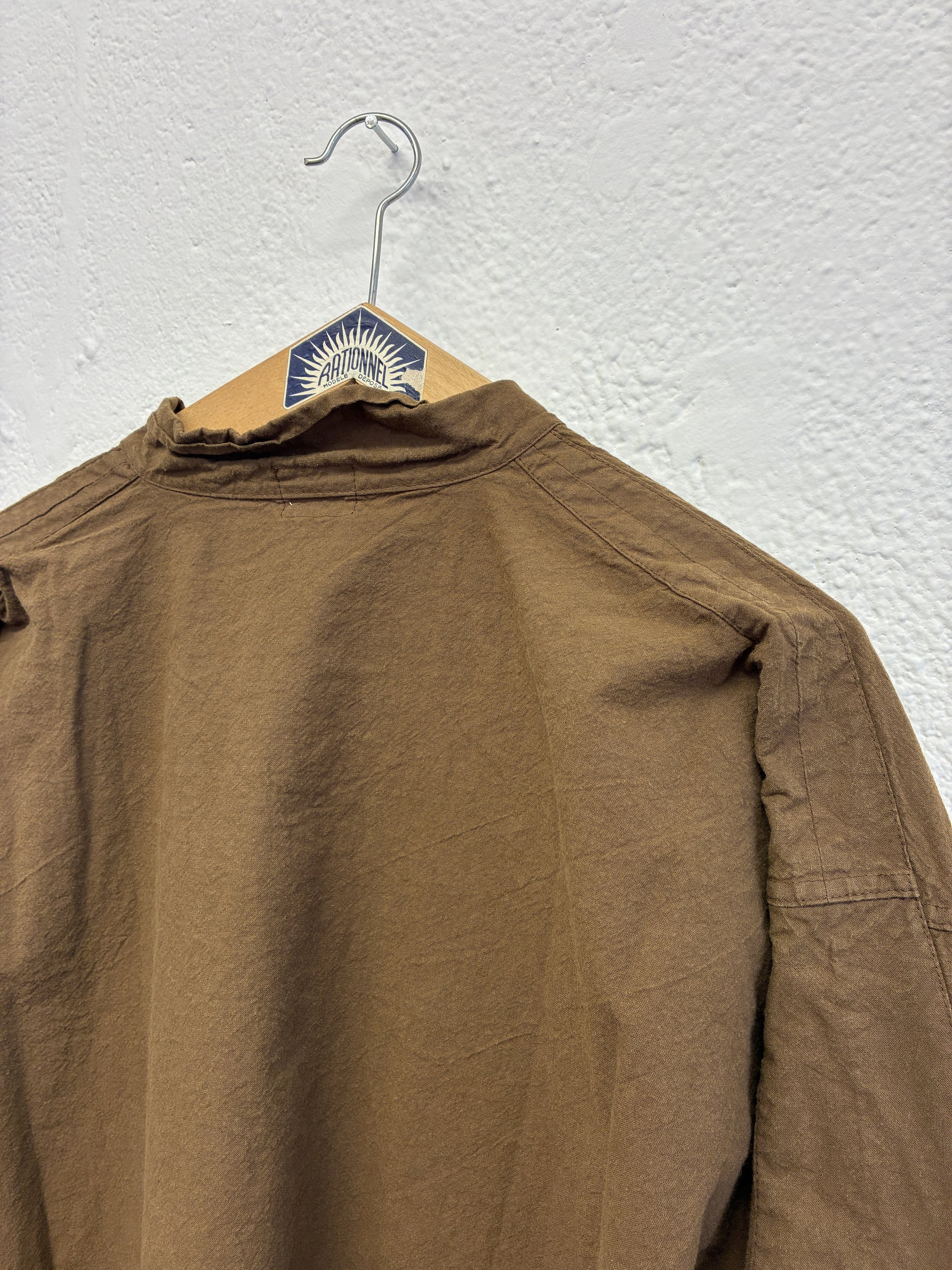 Closeup of back of Tender Co Type 485 Isosceles Brown Hat Shirt  on hanger