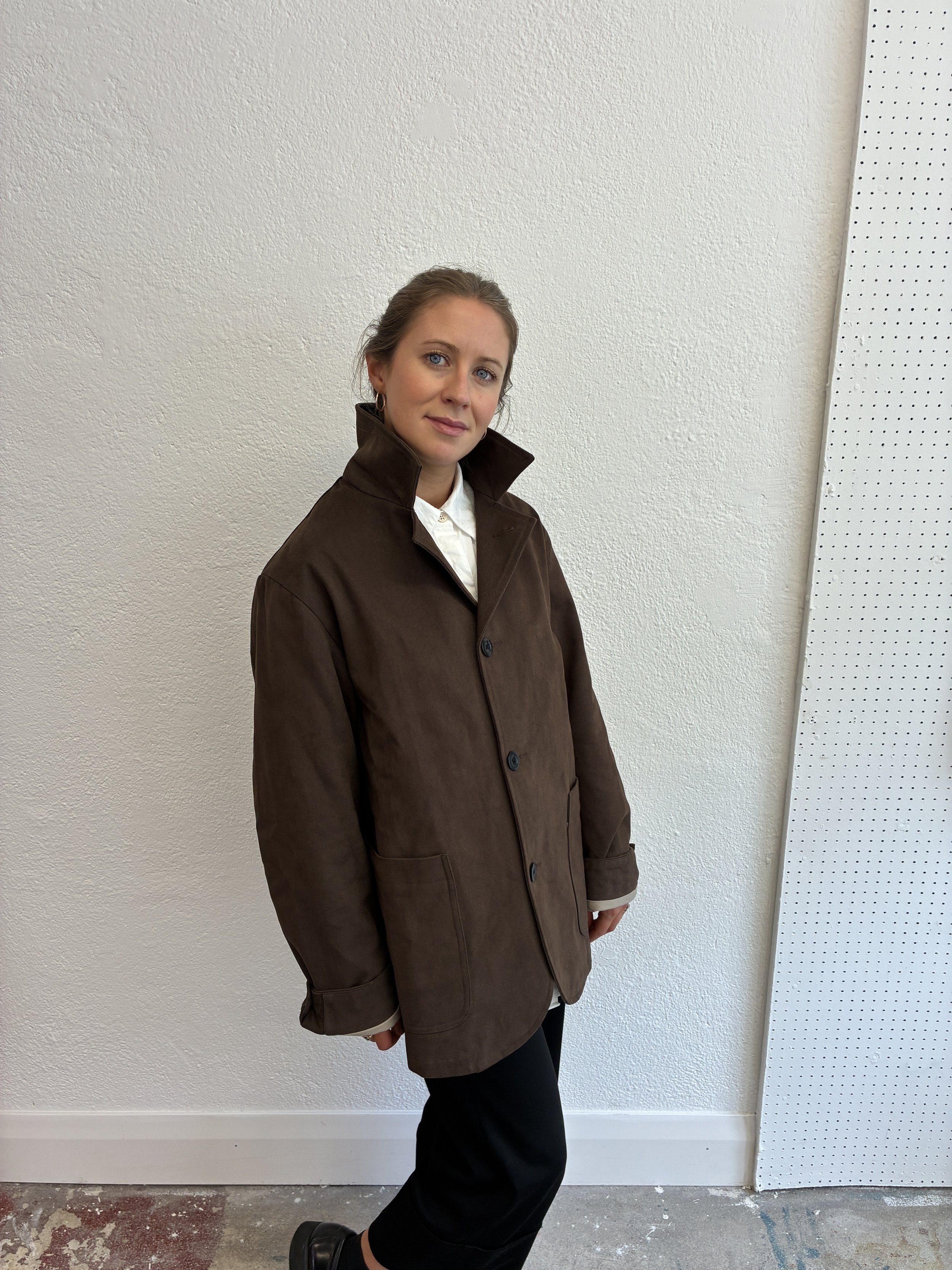 Woman in front of wall wearing Brown Conkers Bruton Blazer Jacket