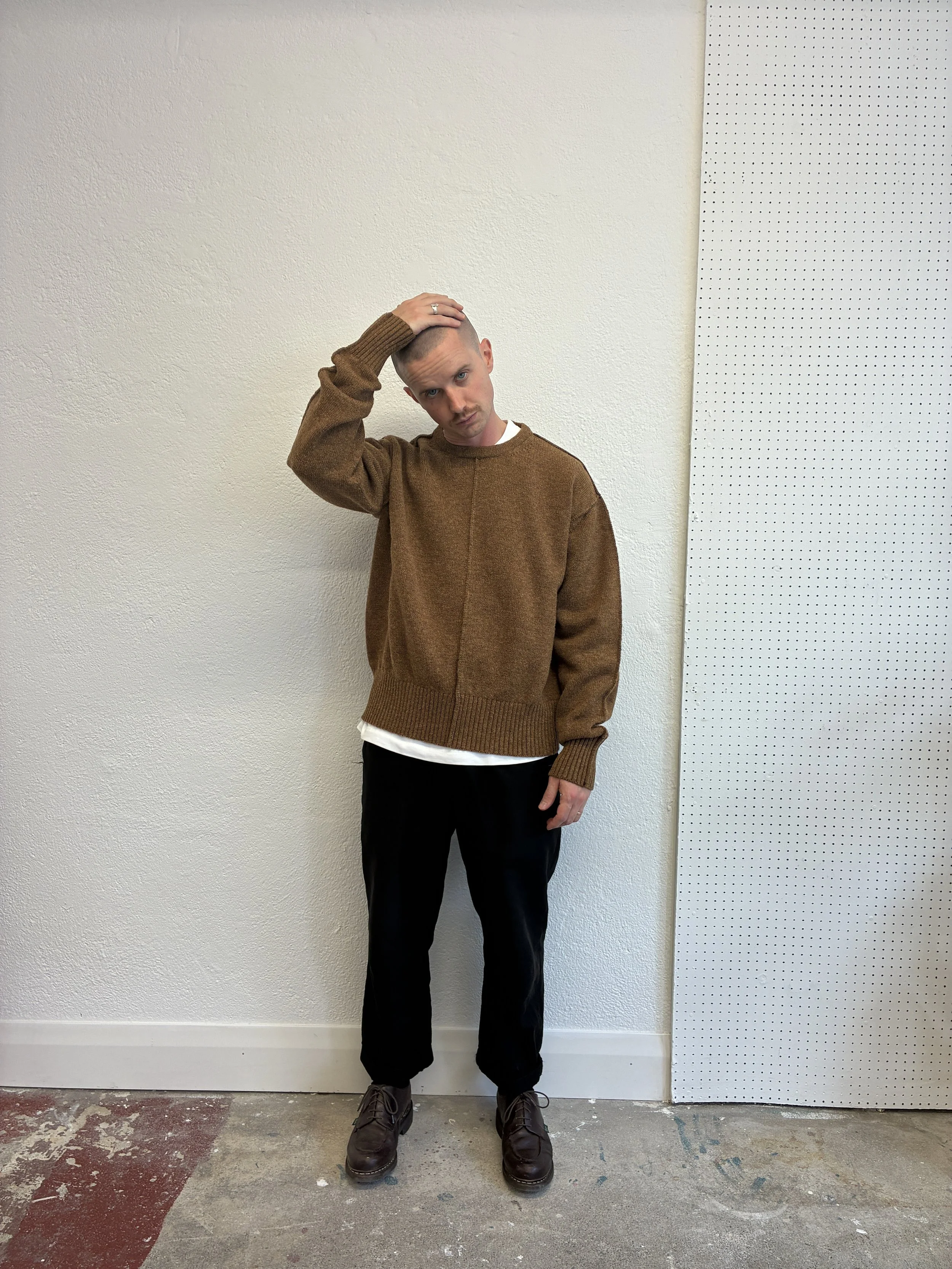 man in front of wall wearing iBrown Tender Co Type 719 Butterfly Jumper