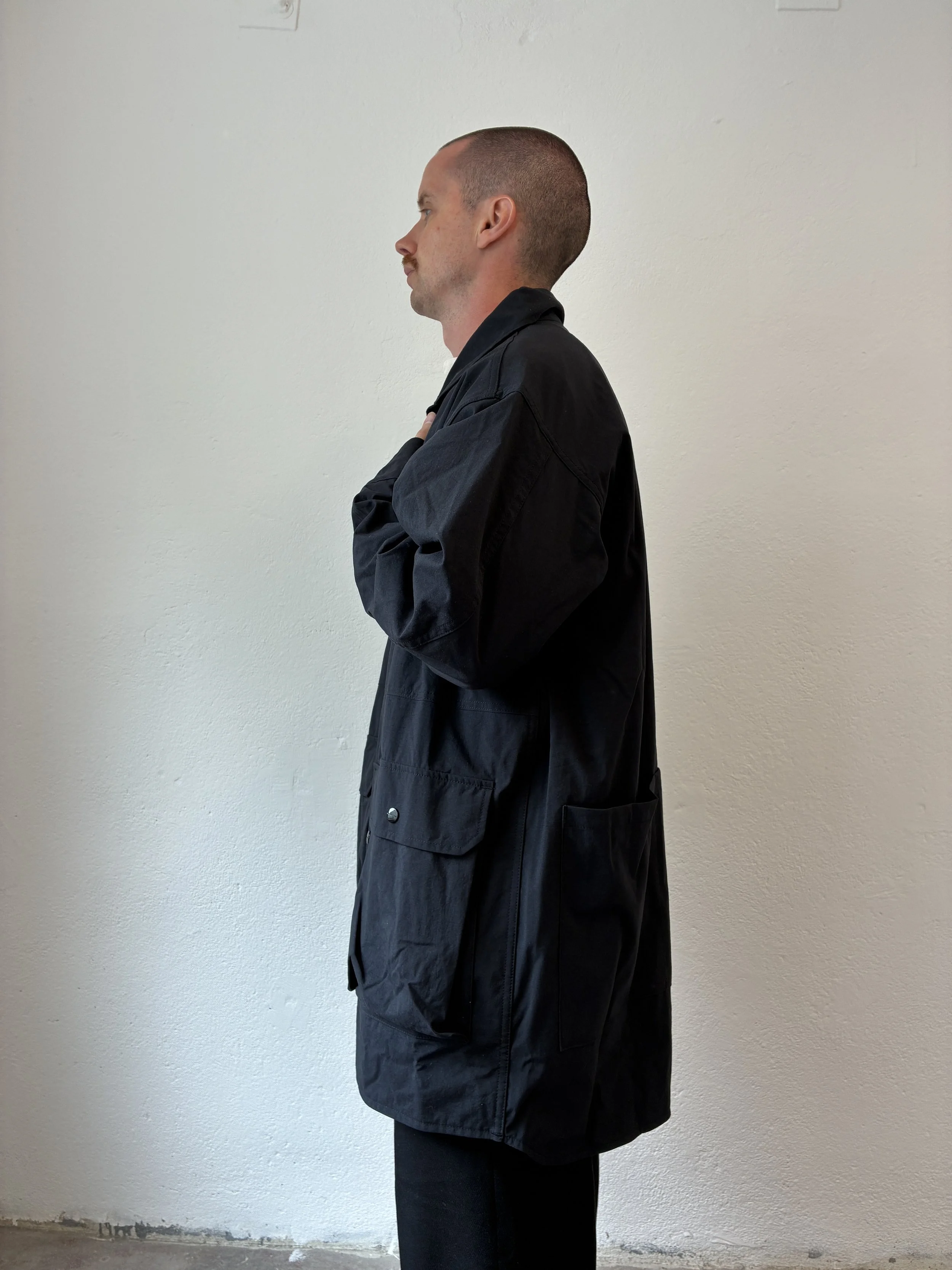 Side of Man wearing Black Sassafras Cultivator Coat