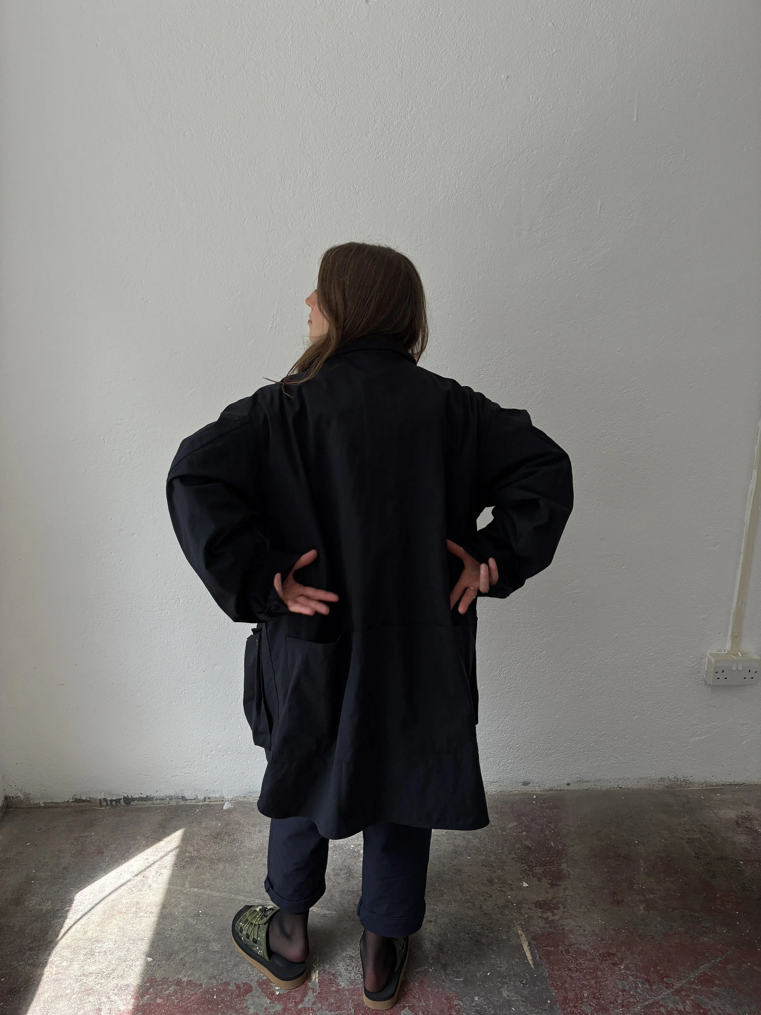 Back of Woman wearing Black Sassafras Cultivator Coat inside