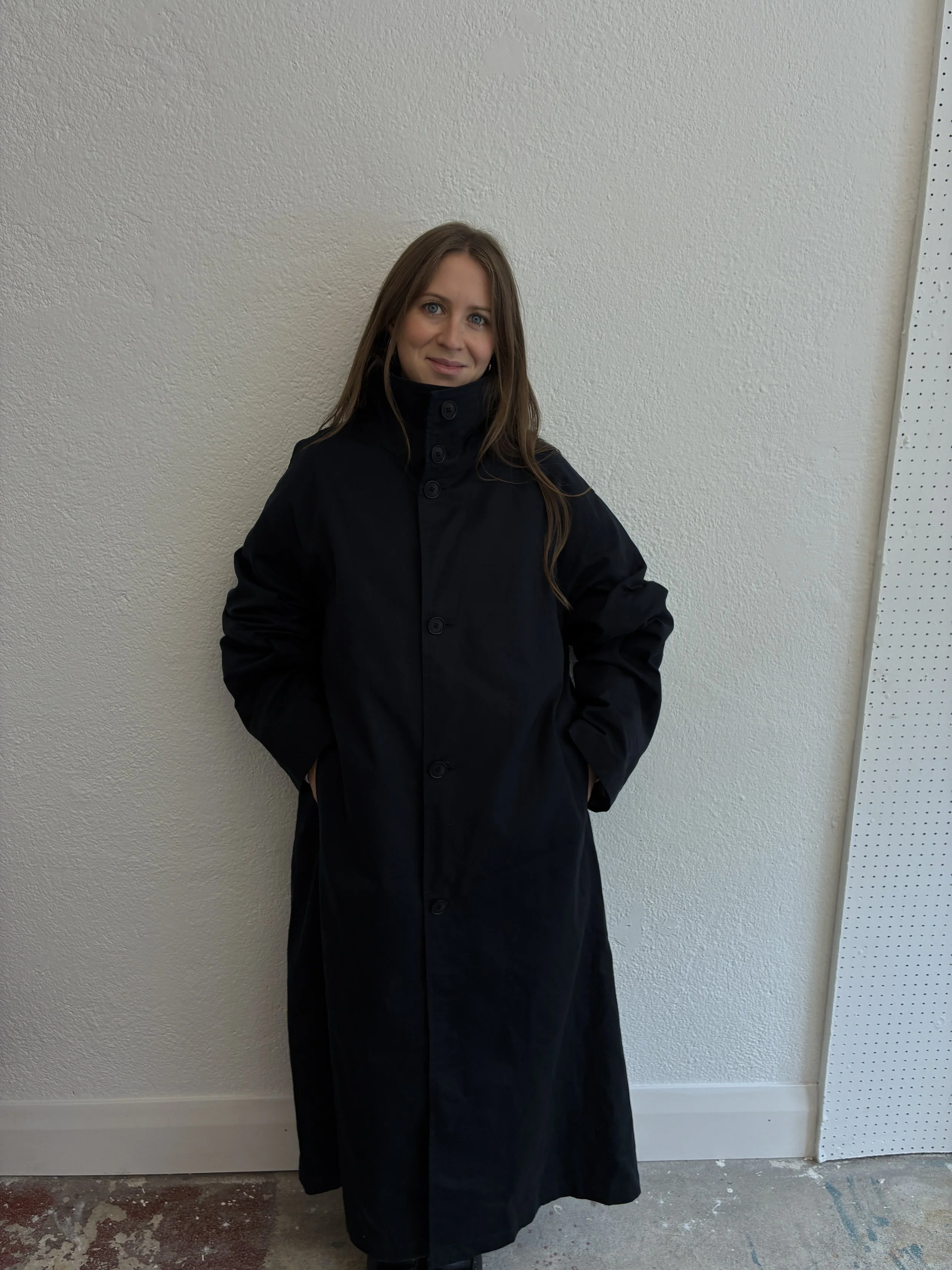 Woman smiling wearing Navy De Dam Foundation Cotton Gabardine Trench Coat