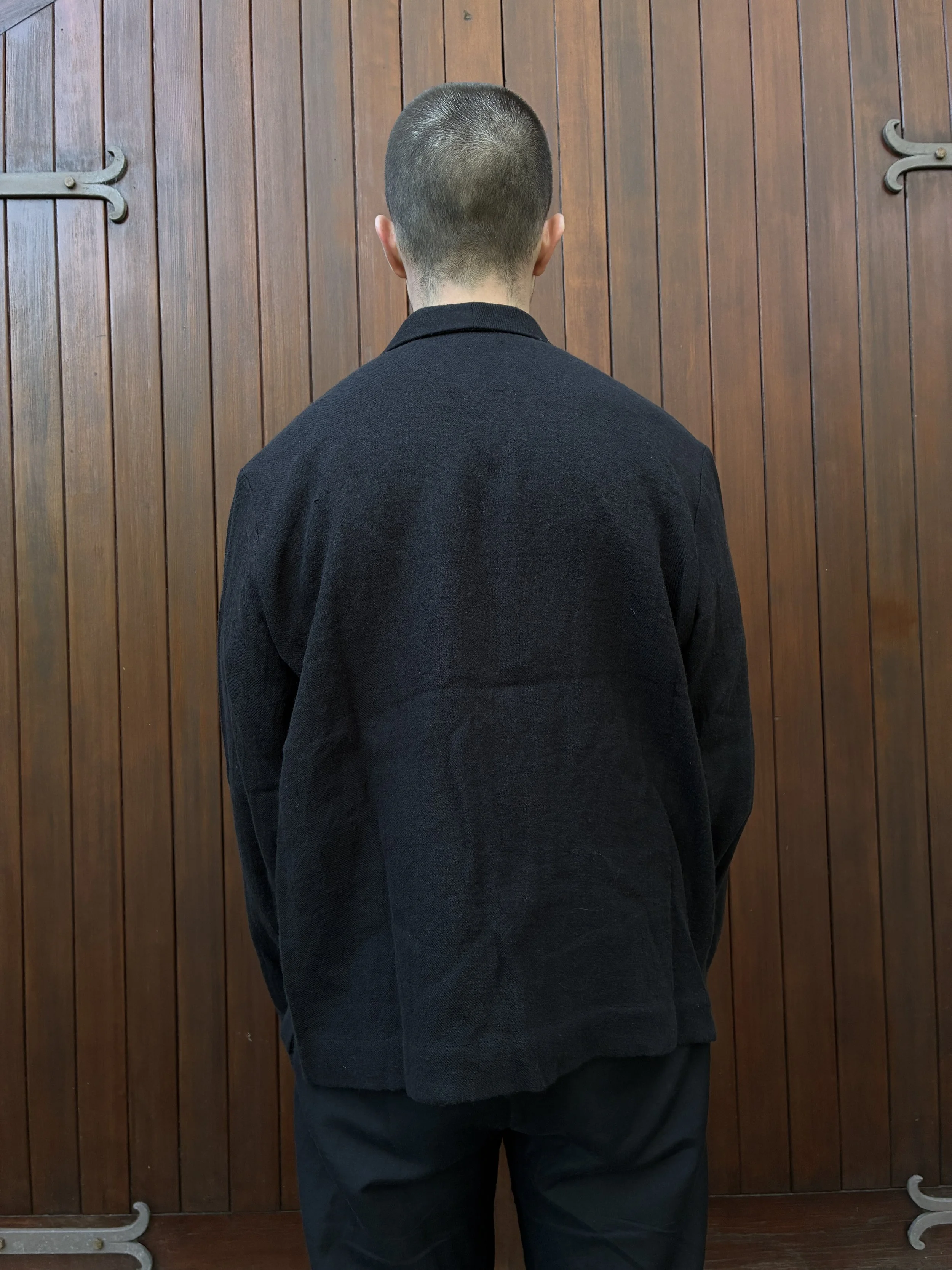 Back of man in front of door wearing Frank Leder Black Wool Shirt Jacket