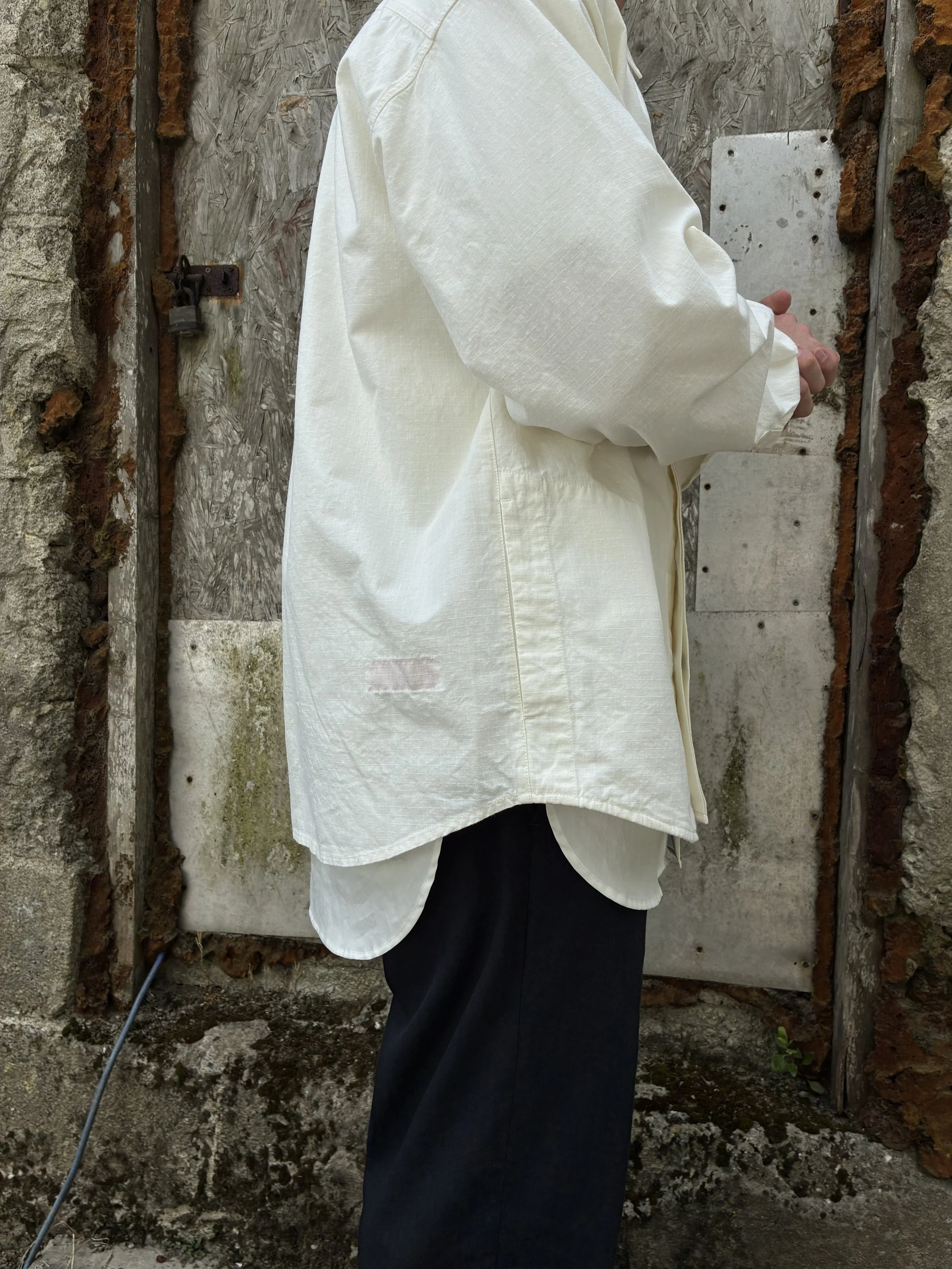 Bottom half of Man in front of wall wearing Off-White Ecru 1st PAT-RN Sumatra Overshirt