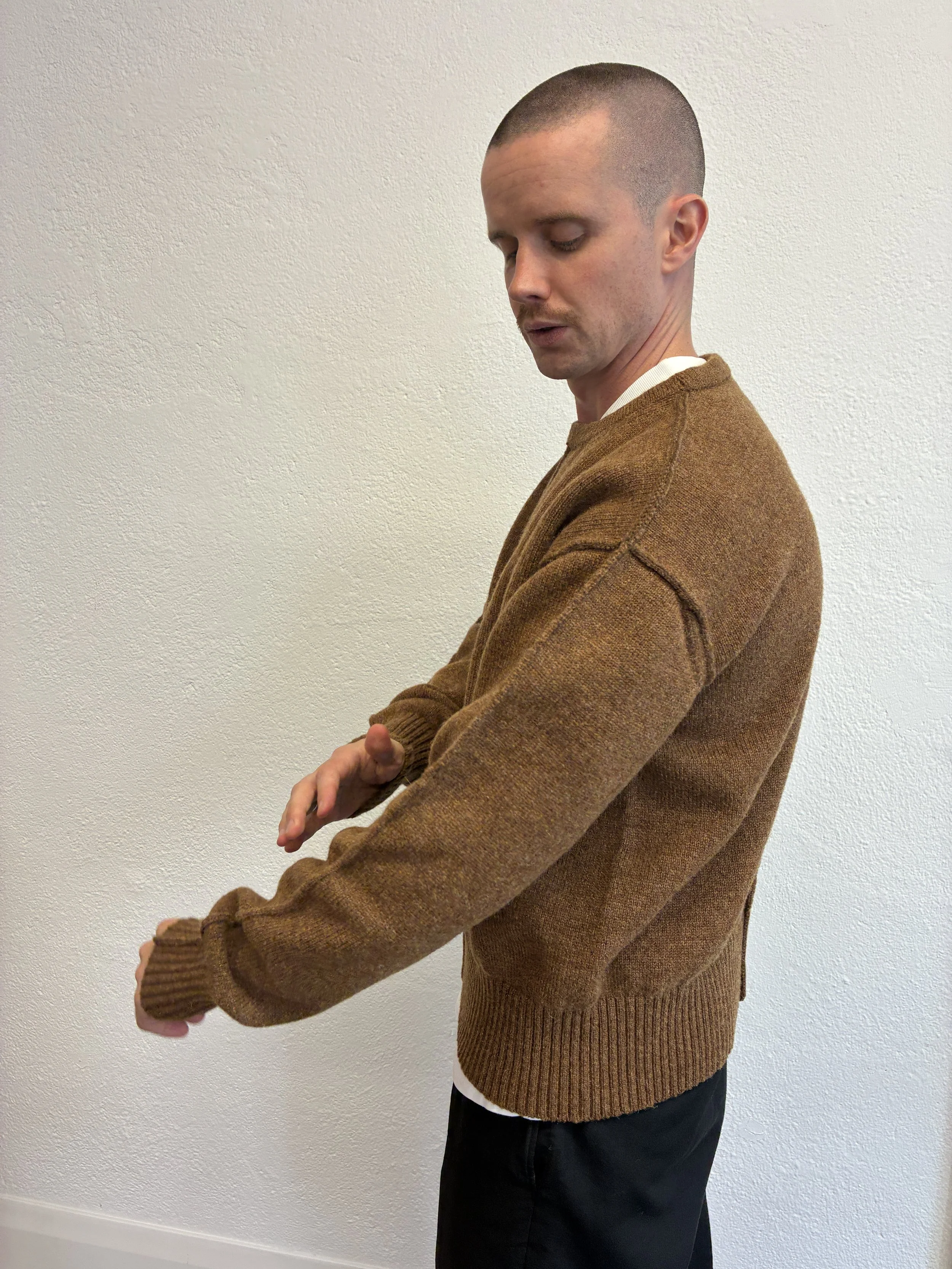 Side of man in front of wall wearing Brown Tender Co Type 719 Butterfly Jumper