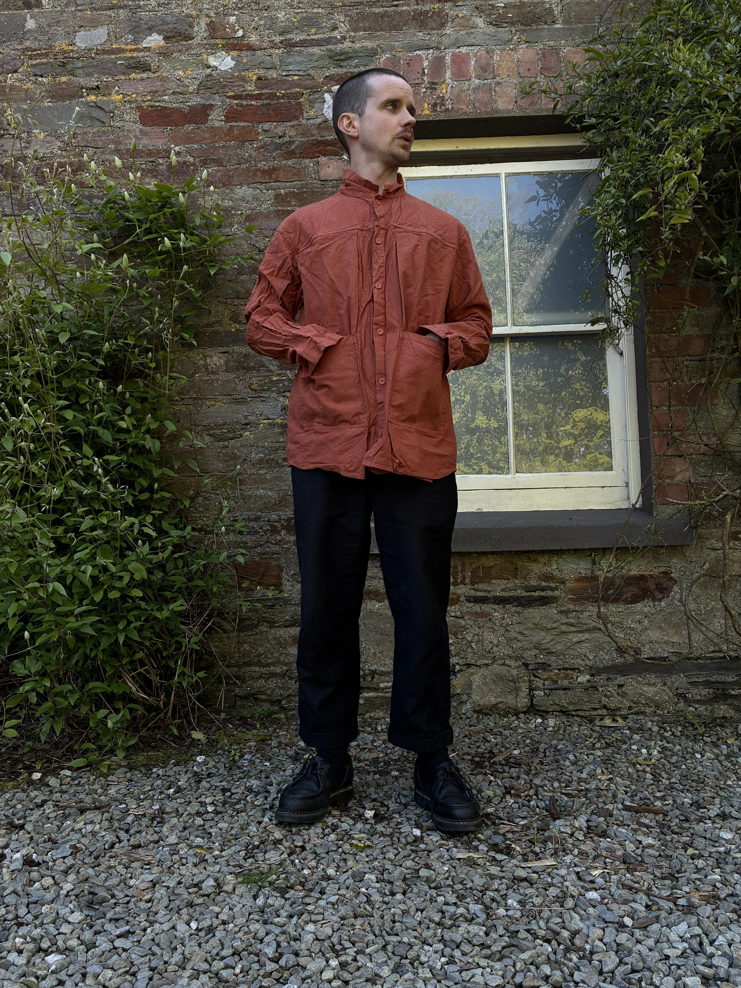 Man wearing orange Tender 402 Two Birds Shirt outside