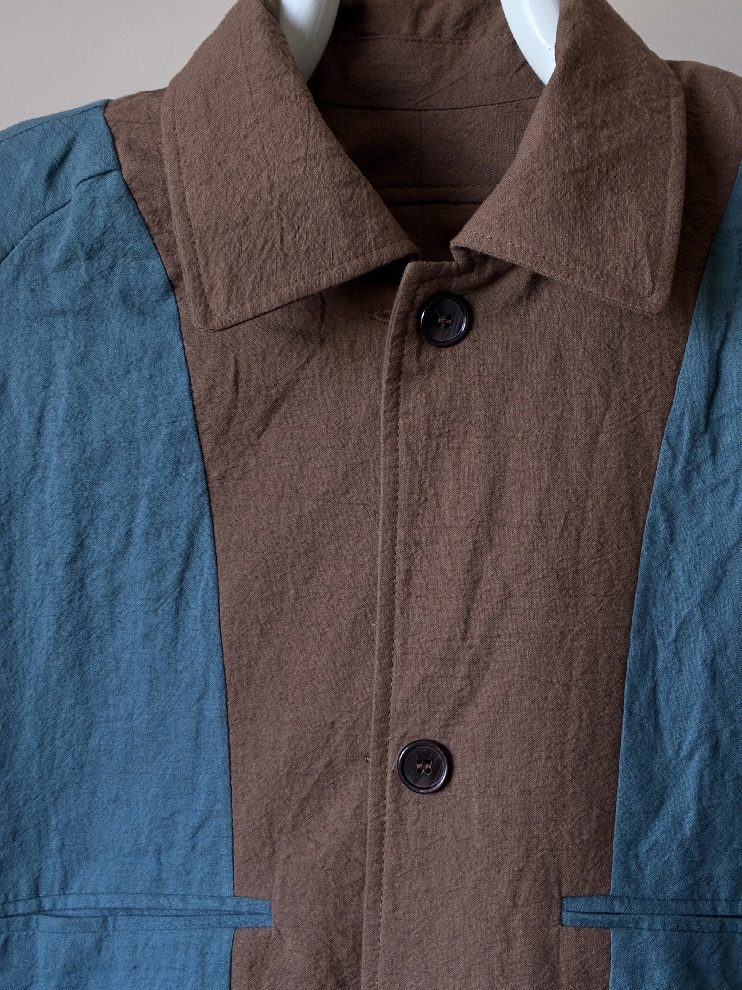 Close up of reversible side of Frank Leder teal coat
