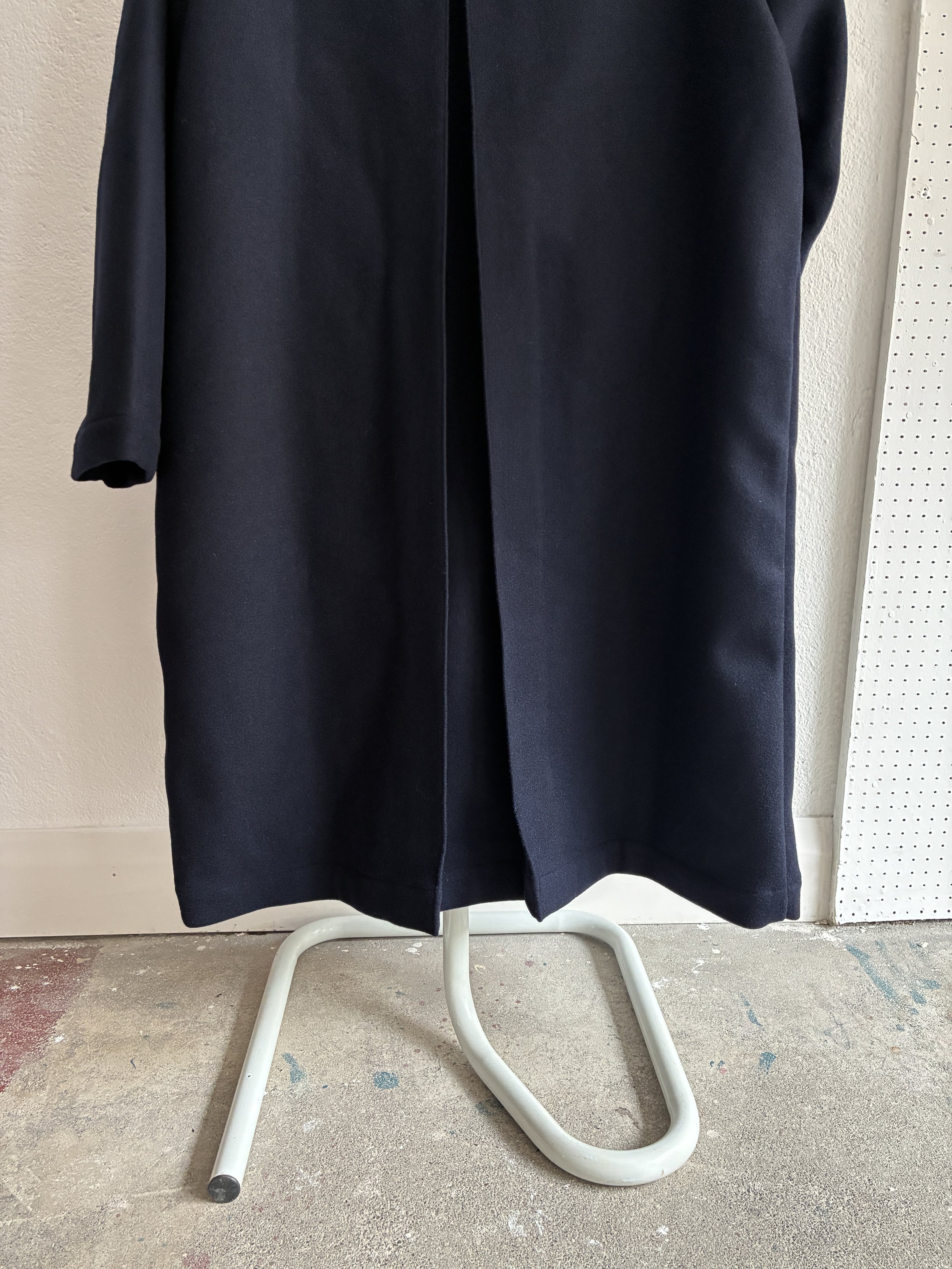 Bottom of Frank Leder Navy Wool Duster Coat on mannequin