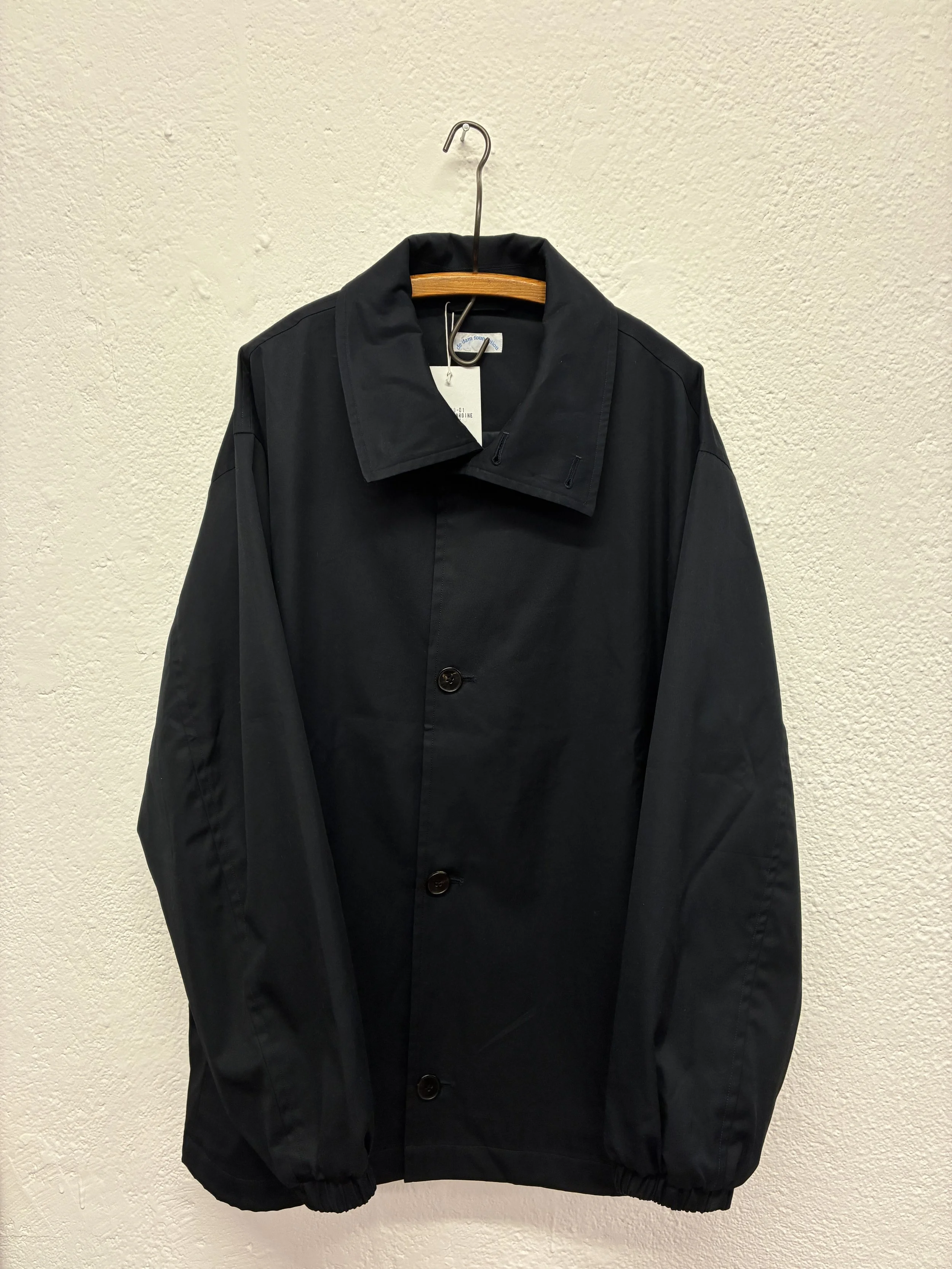 Navy De Dam Foundation Cotton Gabardine Jacket on hanger