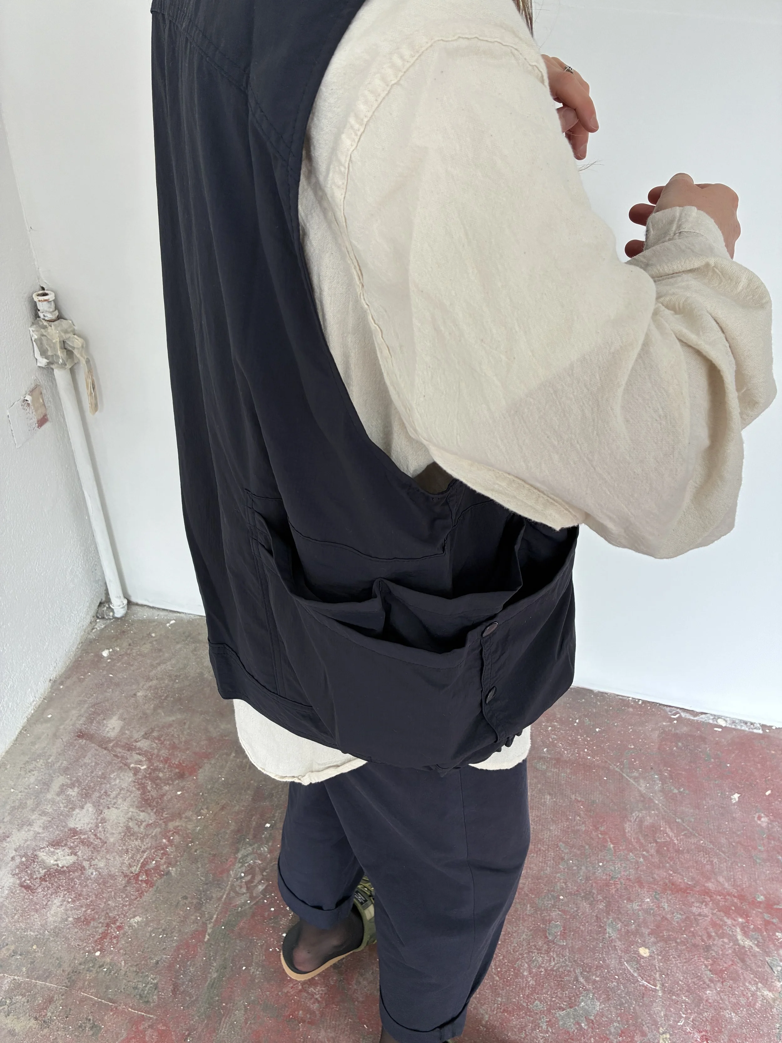 Closeup of side of person wearing Navy Sassafras Overgrown Hiker Vest