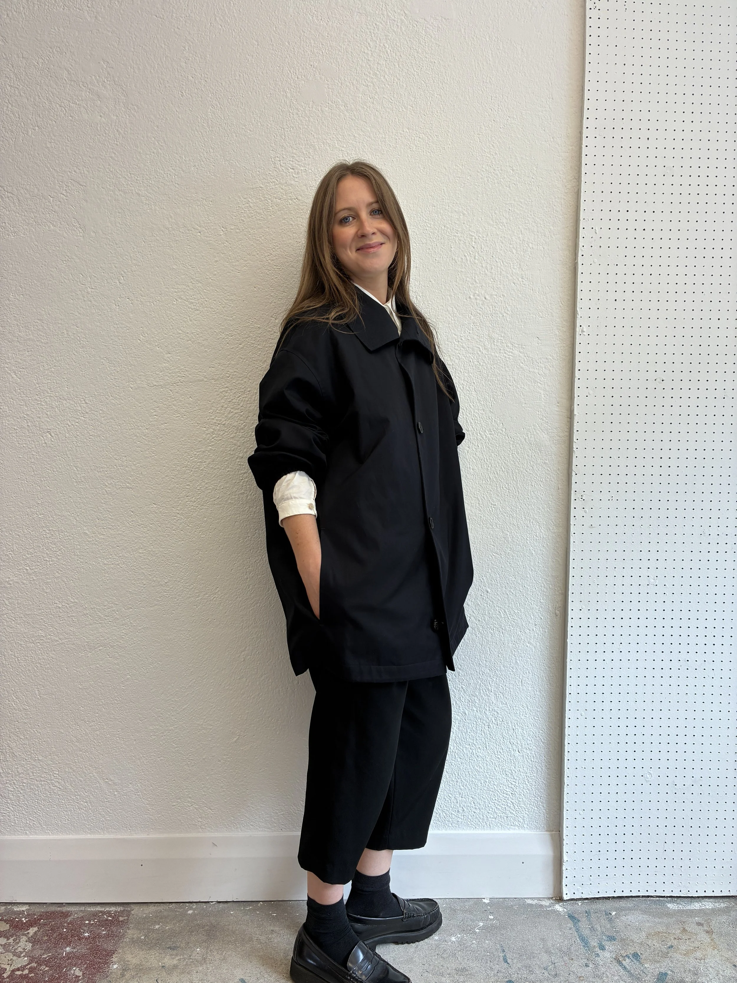 Woman smiling at camera wearing Navy De Dam Foundation Cotton Gabardine Jacket