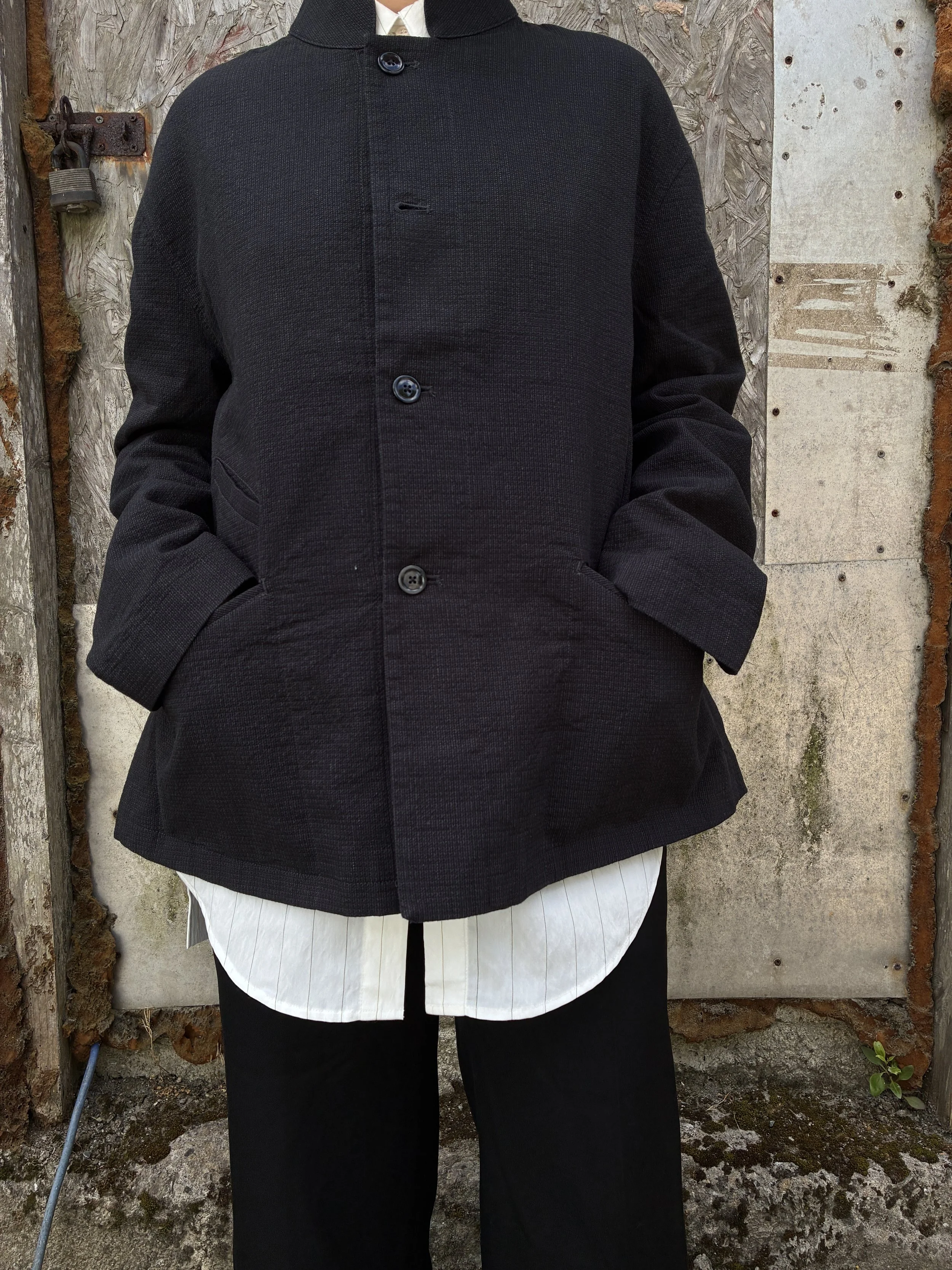 Closeup of Woman in front of wall wearing Charcoal 1st PAT-RN Woman Rei Jacket